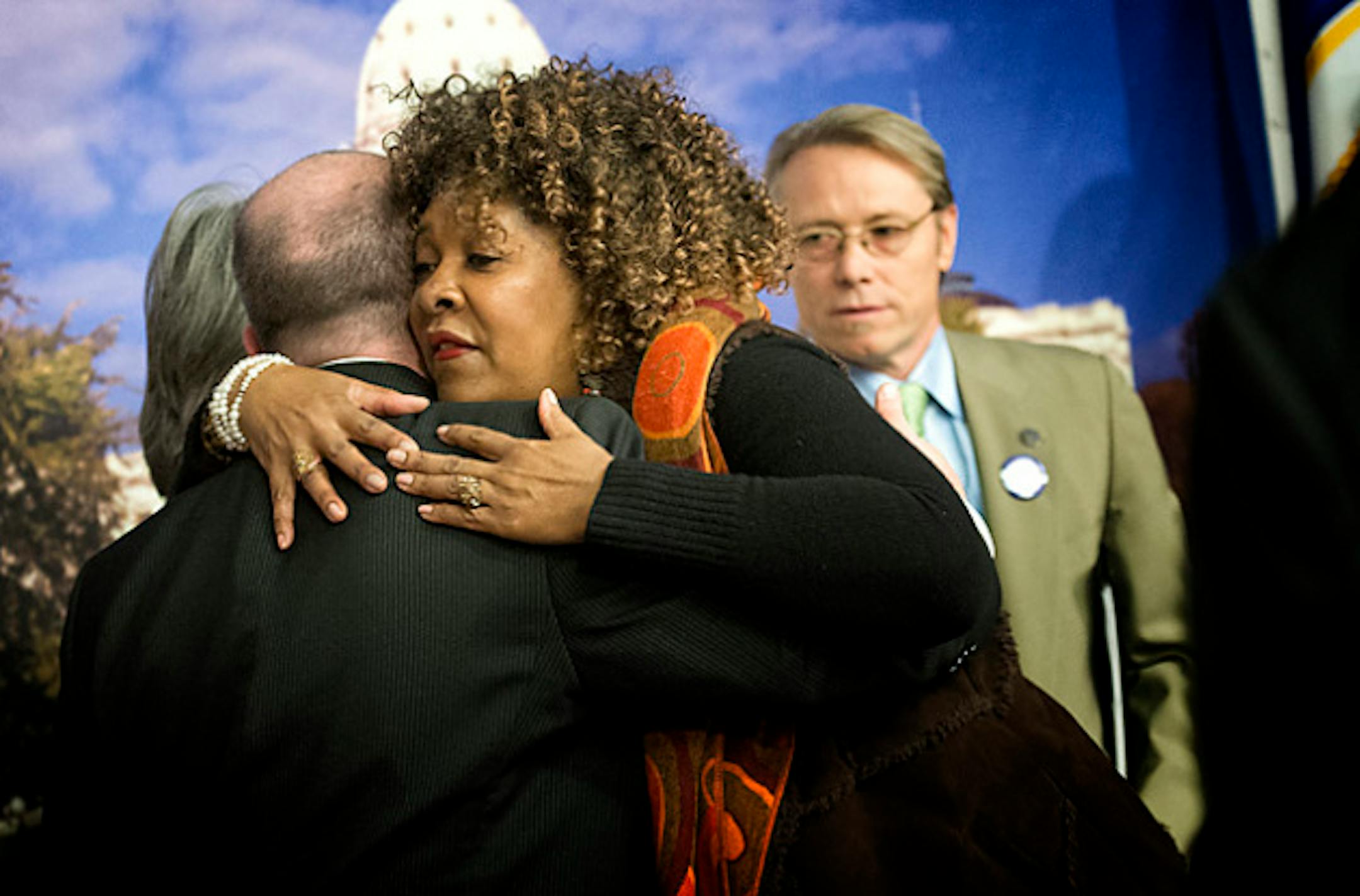 Rose McGee hugged Rep. Raymond Dehn Wednesday, January 16, 2013. Rose is fighting to keep her foreclosed home just blocks away from Dehn.  Dehn along with Rep. Mike Freiberg, right and Rep. Karen Clark sponsored a bill that would protect homeowners and ensure greater transparency from lenders.   ]   GLEN STUBBE * gstubbe@startribune.com