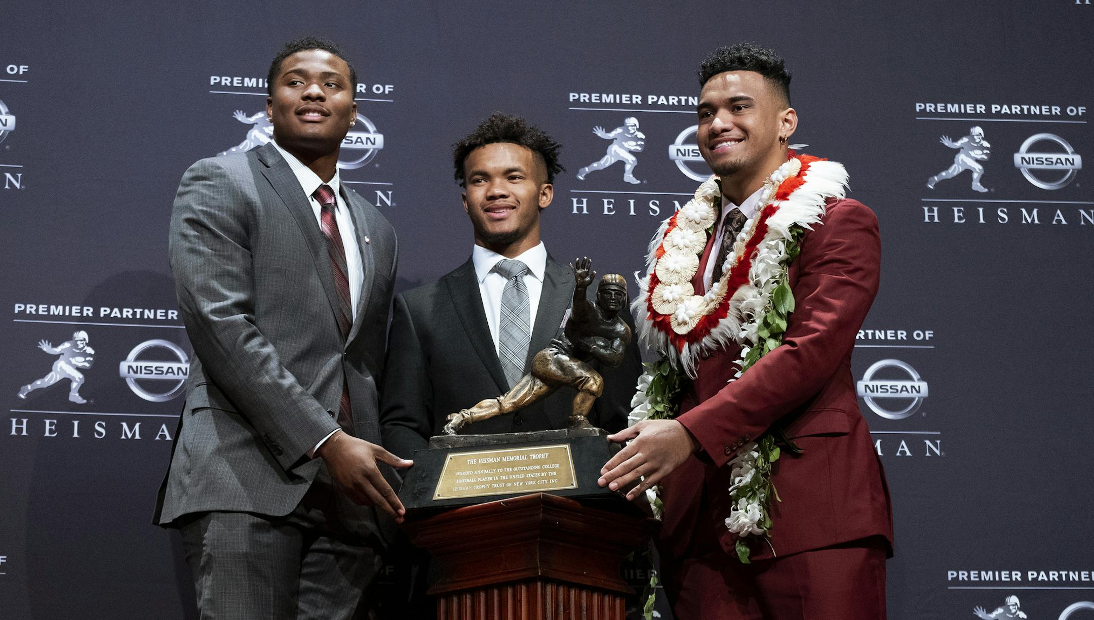 Heisman Trophy finalists, from left, Dwayne Haskins, from Ohio State; Kyler Murray, from Oklahoma; and Tua Tagovailoa, from Alabama, pose with the tophy during a media event Saturday, Dec. 8, 2018, in New York. (AP Photo/Craig Ruttle)