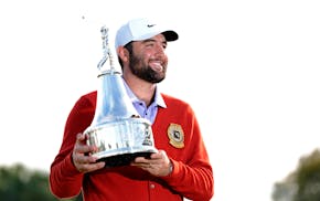 Scottie Scheffler holds the championship trophy after winning the Arnold Palmer Invitational on Sunday.