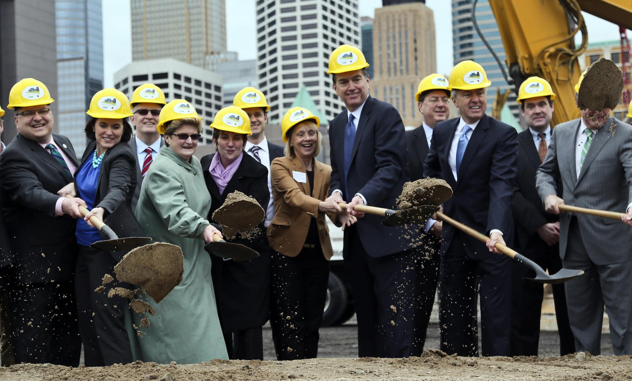 Dignitaries toss dirt for the groundbreaking for the $400 million Downtown East project on the former Star Tribune Company Offficials from Wells Fargo, Ryan Cos. and the city took part, including Minneapolis mayor Betsy Hodges, third from left, and John Stumpf, chairman, president and CEO of Wells Fargo Great Lakes Region , third from right.](DAVID JOLES/STARTRIBUNE) djoles@startribune Groundbreaking for the $400 million Downtown East project, with officials from Wells Fargo, Ryan Cos. and the c