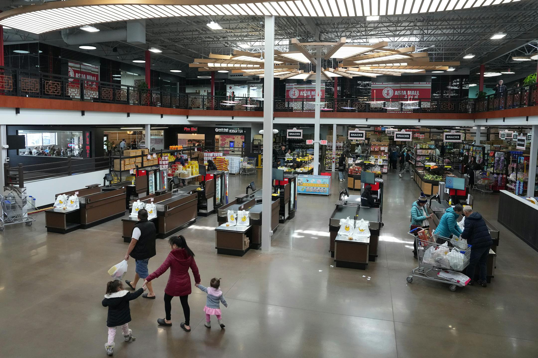 Customers peruse the grocery selections inside the new Asia Mall.
