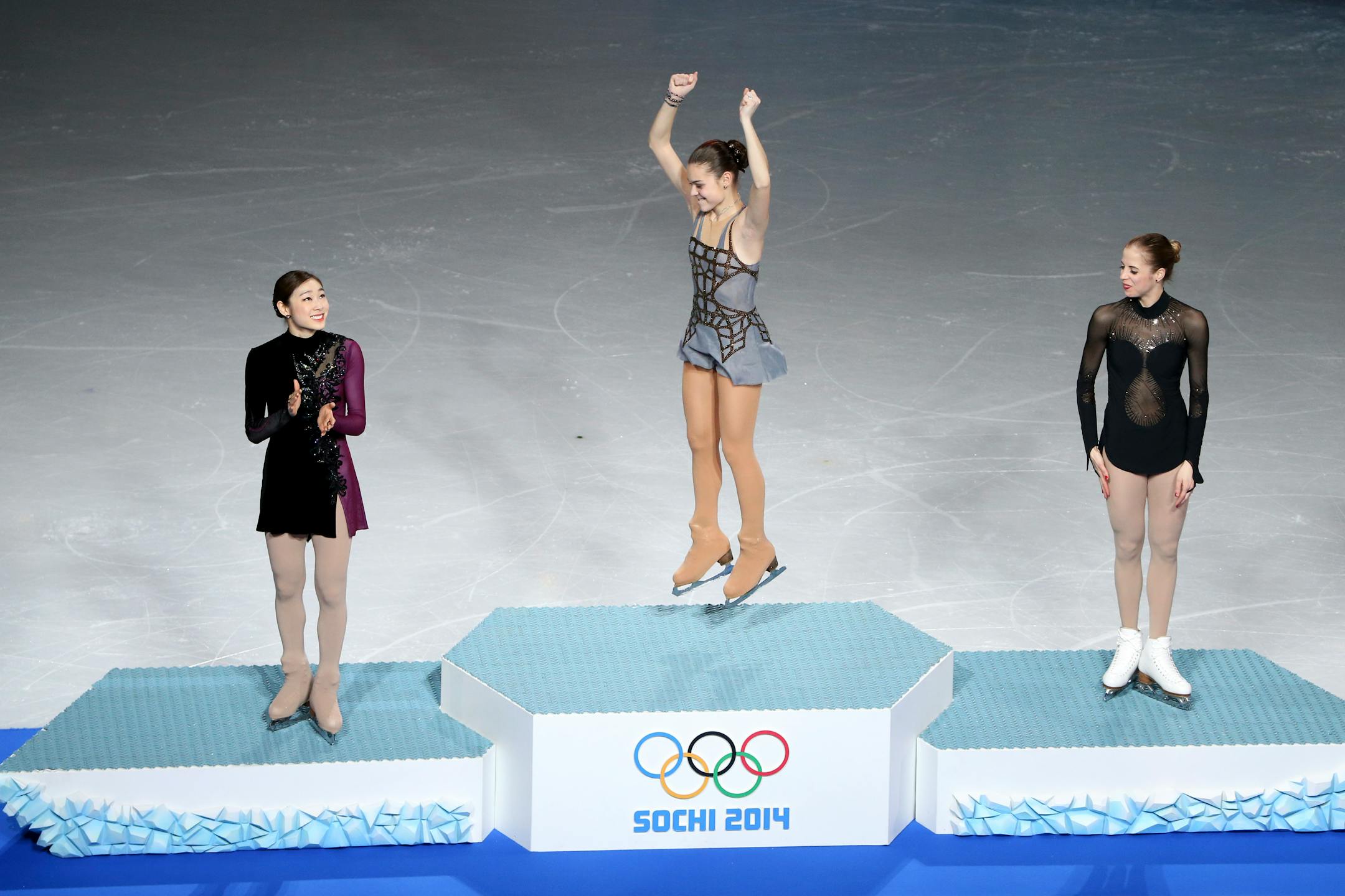 Adelina Sotnikova of Russia, center, celebrates her gold medal in women's figure skating in the 2014 Winter Olympics, at the Iceberg Skating Palace in Sochi, Russia, Feb. 20, 2014. Yuna Kim of South Korea, left, won silver and Carolina Kostner of Italy, right, won bronze. (Josh Haner/The New York Times)