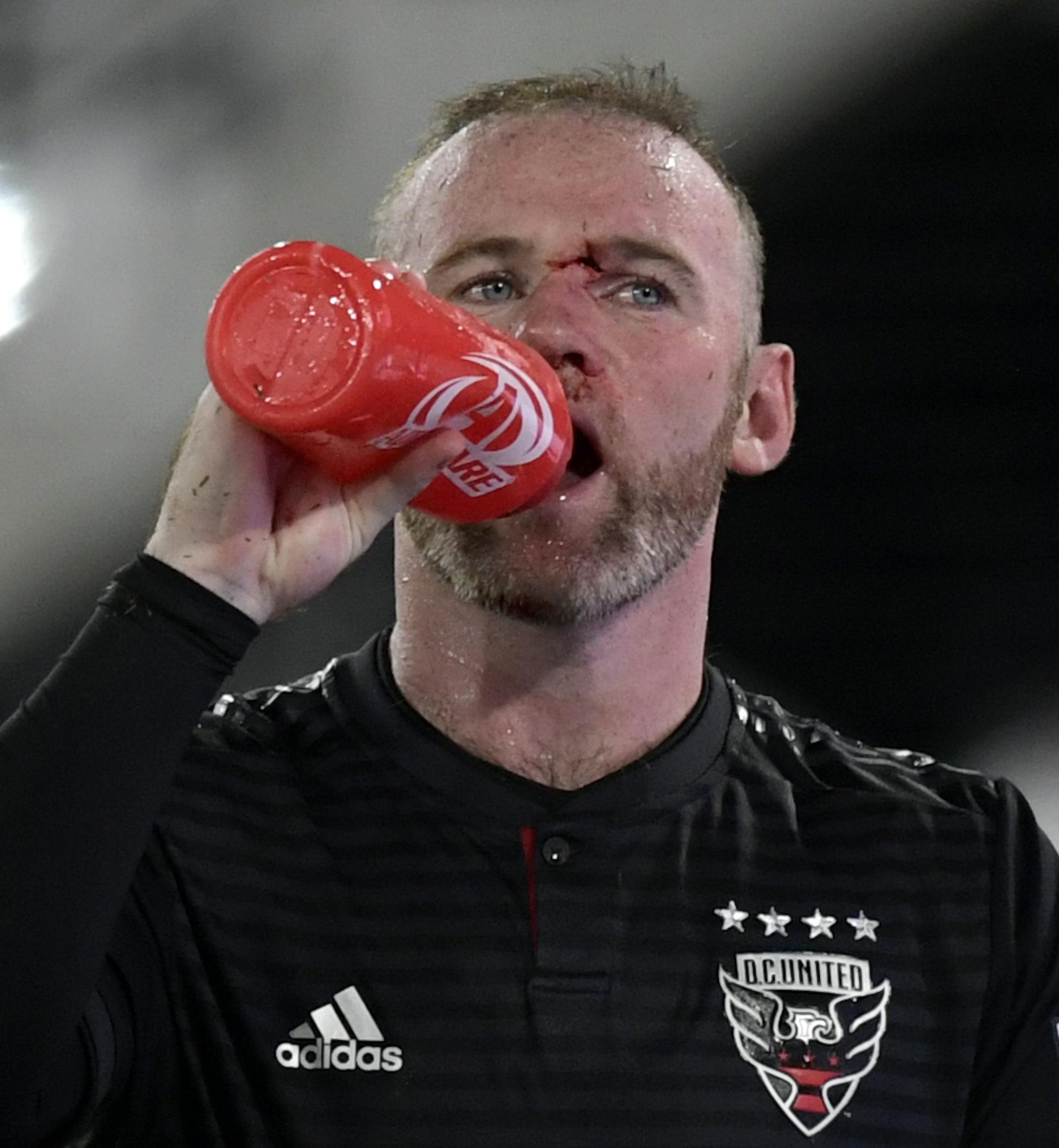 D.C. United forward Wayne Rooney drinks as he leaves the field at the end of an MLS soccer game after getting injured during the second half against the Colorado Rapids in Washington, Saturday, July 28, 2018. (AP Photo/Susan Walsh) ORG XMIT: DCSW109