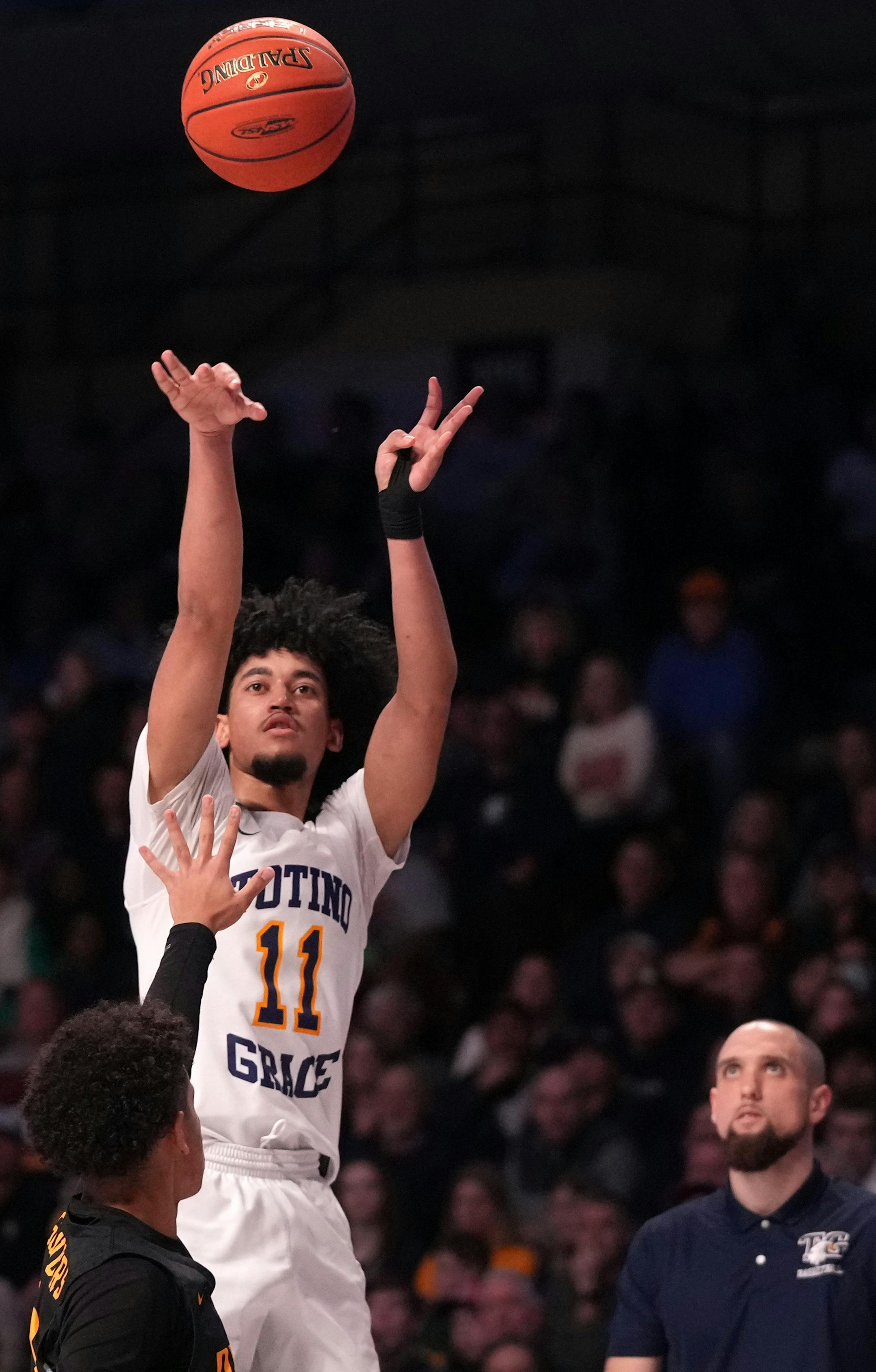 Totino-Grace guard Taison Chatman (11) went up for an outside shot as his head coach Nick Carroll looked on in the second half of the MSHSL boys basketball Class 3A state championship game between Totino-Grace and DeLaSalle Saturday, March 26, 2022 at Williams Arena in Minneapolis. ] ANTHONY SOUFFLE • anthony.souffle@startribune.com