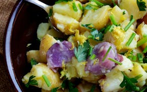 Creating potato salads that are the always-welcome-at-a-party side dish. Here, Lemon, Garlic and Chili Potato Salad. Illustrates POTATOSALAD (category