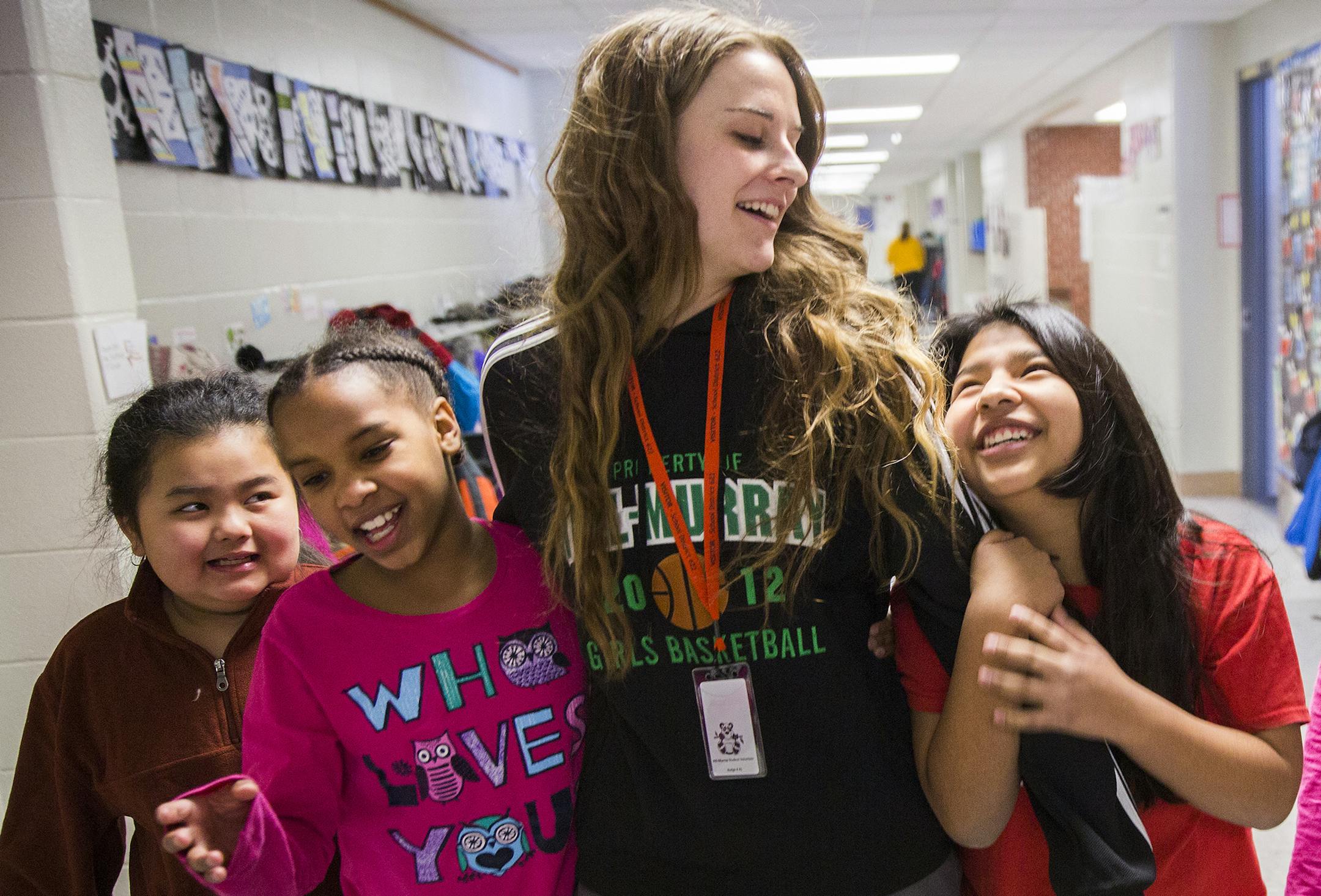 Hill-Murray senior Olivia Graskewicz, center, walked with fourth-graders (from left) Alicia Thao, Dayvona Nins and Rose Newpower.