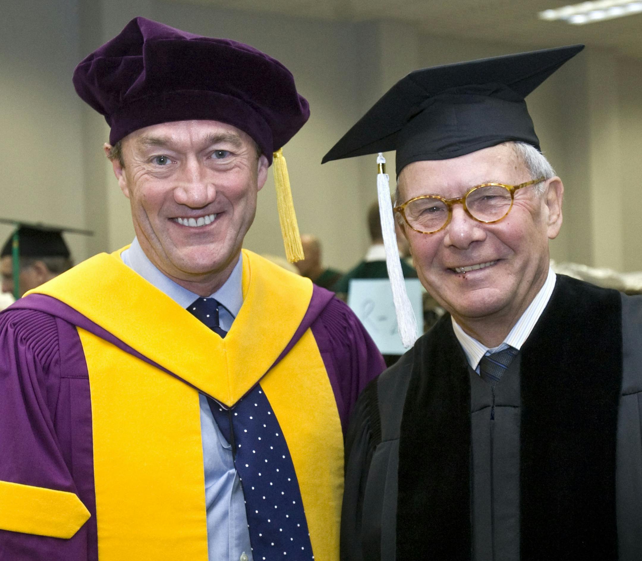 Former news anchor Tom Brokaw, right, poses for a photo after receiving an honorary degree from the Mayo Clinic College of Medicine, Saturday, May 18, 2013, during a graduation ceremony at the Mayo Civic Center in Rochester, Minn. The 73-year-old journalist, who hosted NBC Nightly News for 22 years, became the first recipient of an honorary degree from the college. At left is Mayo Clinic President and CEO Dr. John Noseworthy. (AP Photo/The Rochester Post-Bulletin, Jerry Olson)