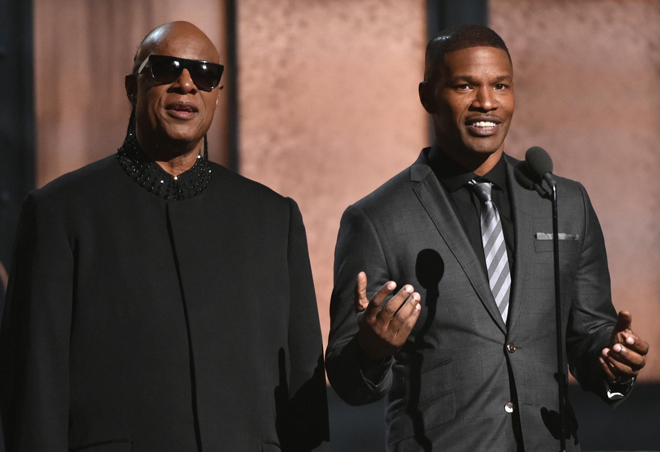 Stevie Wonder, left, and Jamie Foxx present the award for record of the year at the 57th annual Grammy Awards on Sunday, Feb. 8, 2015, in Los Angeles. (Photo by John Shearer/Invision/AP)