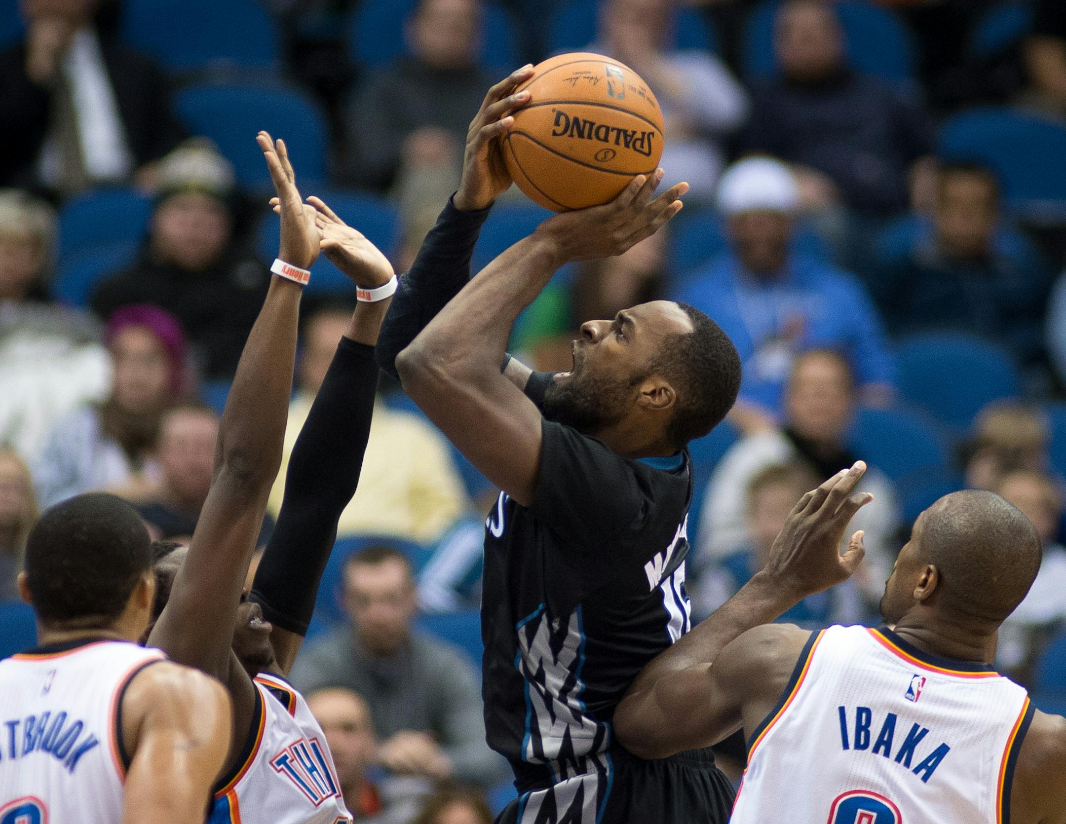 Minnesota Timberwolves forward Shabazz Muhammad (15) attempts a shot but is fouled by Oklahoma City Thunder guard Reggie Jackson (15) during the fourth quarter. ] AARON LAVINSKY • aaron.lavinsky@startribune.com The Minnesota Timberwolves take on the Oklahoma City Thunder Friday, Dec. 12, 2014 at Target Center in Minneapolis, Minn.
