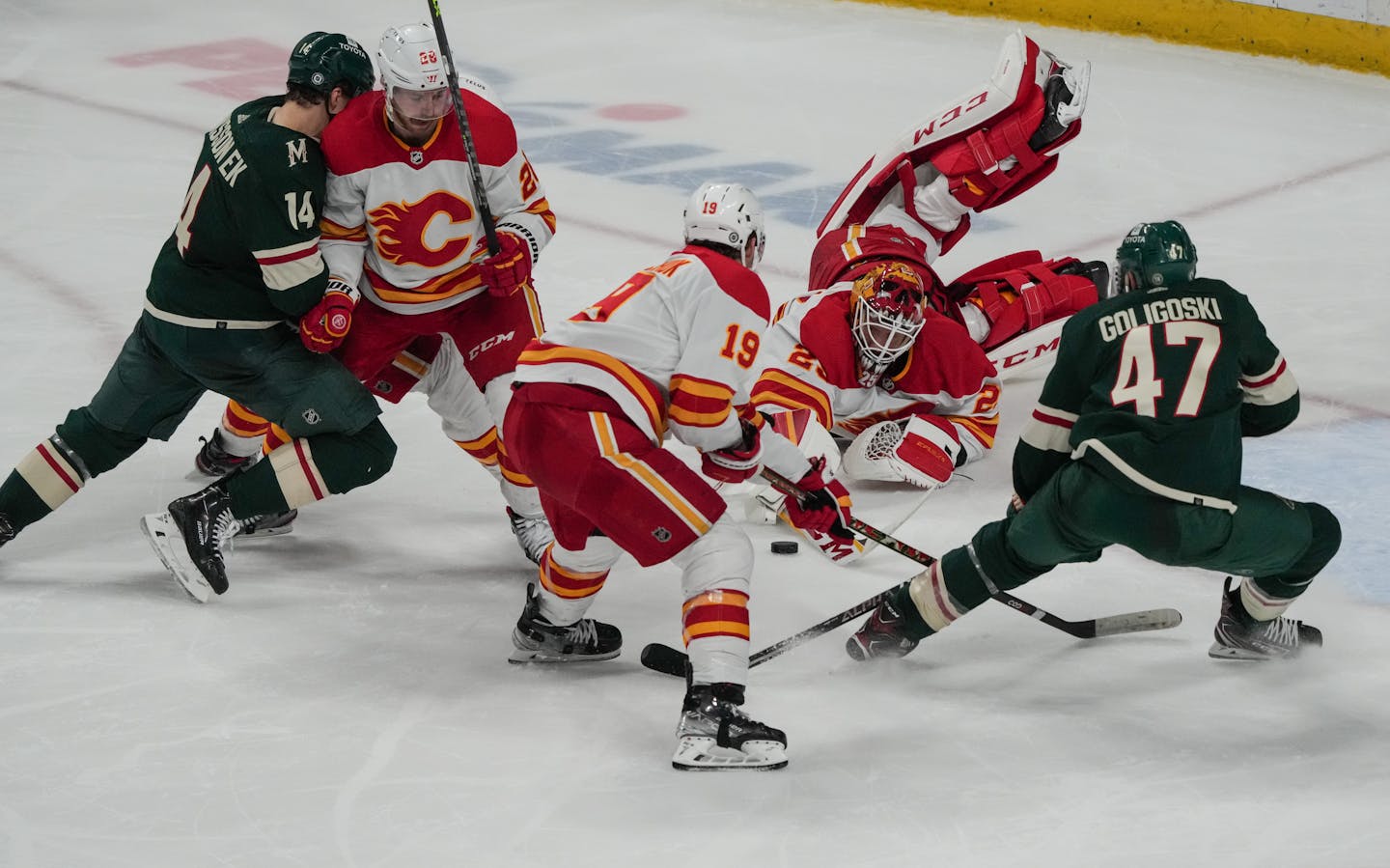 Wild and Flames players, including Calgary Flames goaltender Jacob Markstrom (25) pile up striving for the puck in the third period. The Minnesota Wild hosted the Calgary Flames at the Xcel Energy Center on Thursday, April 28, 2022 in St. Paul, Minn. ] RENEE JONES SCHNEIDER • renee.jones@startribune.com