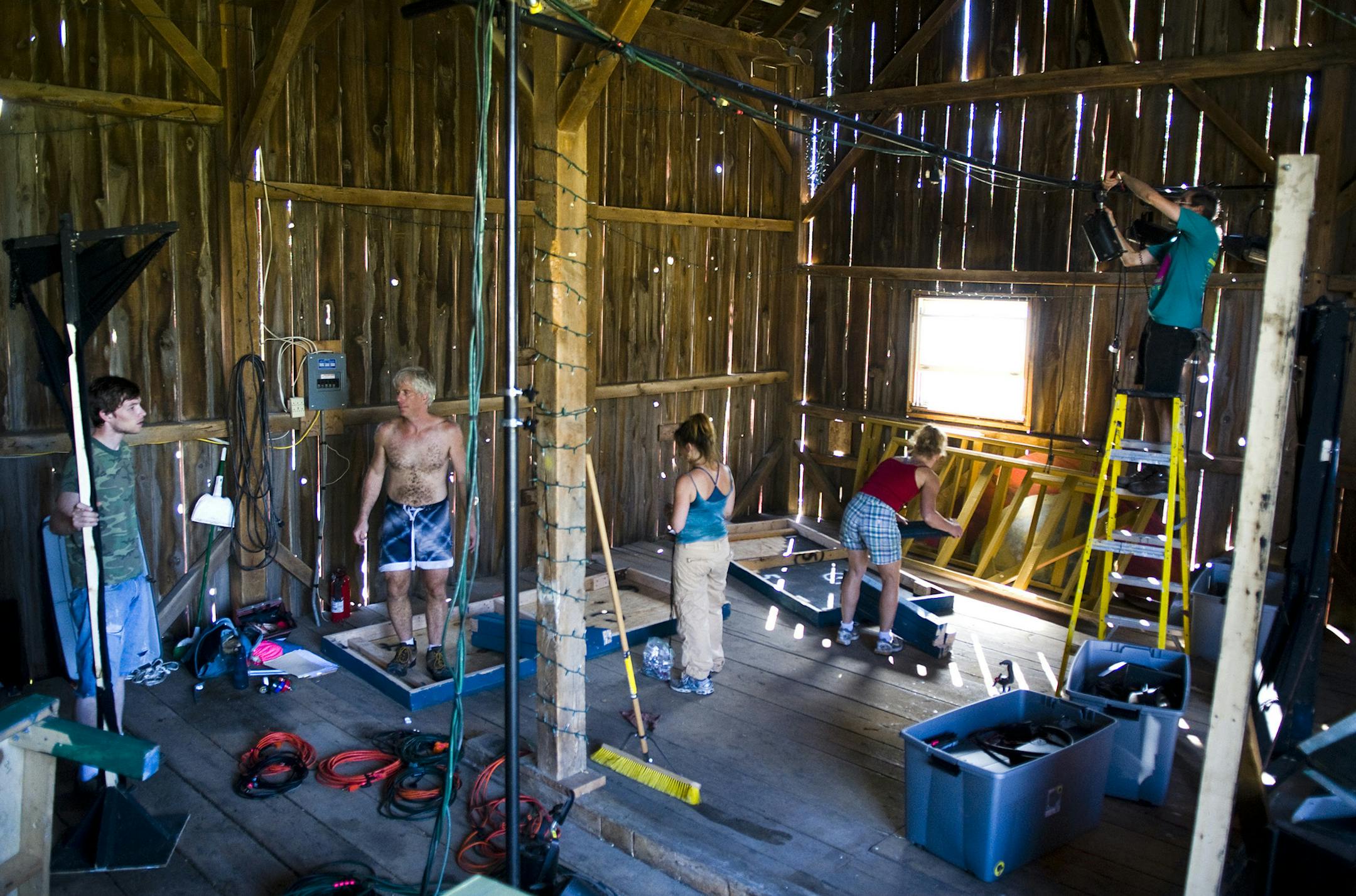 BRENDAN SULLIVAN • brendan.sullivan@startribune.com - PLYMOUTH - August 27, 2010 - Production group, Off-Leash Area prepares for their Friday night performance of A Gift for Planet BX63 in the barn of host Russ Vogt in Plymouth. IN THIS PHOTO: ] Co-Artistic directors, Jennifer Ilse and Paul Herwig, actress, Kym Longhi, production assistant, Phil Khalar and technical director Paul Epton, construct a prop for the Friday night performance of A Gift for Planet BX63 in the barn of host Ru