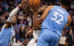 LA Clippers forward Kawhi Leonard (2) tried to muscle through Minnesota Timberwolves center Karl-Anthony Towns (32) for a layup in the fourth quarter.