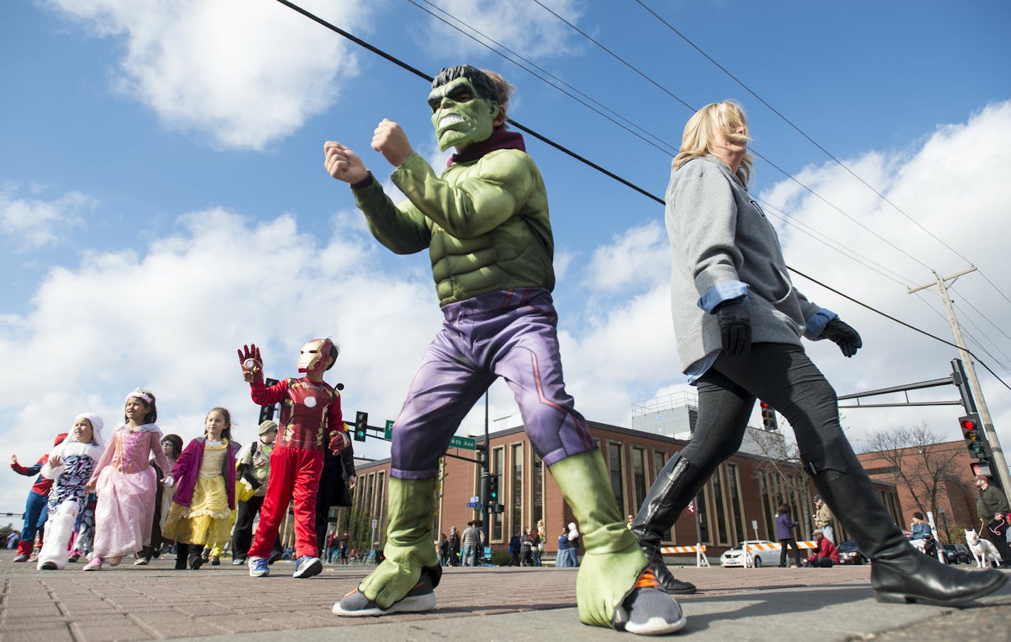 Keaton Maros, 6, of Ramsey, walked with his mother, Michele, during Friday's parade in Anoka. ] (AARON LAVINSKY/STAR TRIBUNE) aaron.lavinsky@startribune.com Local school children walk on Main Street in their festive Halloween costumes as part of Anoka's halloween tradition on Friday, Oct. 30, 2015.