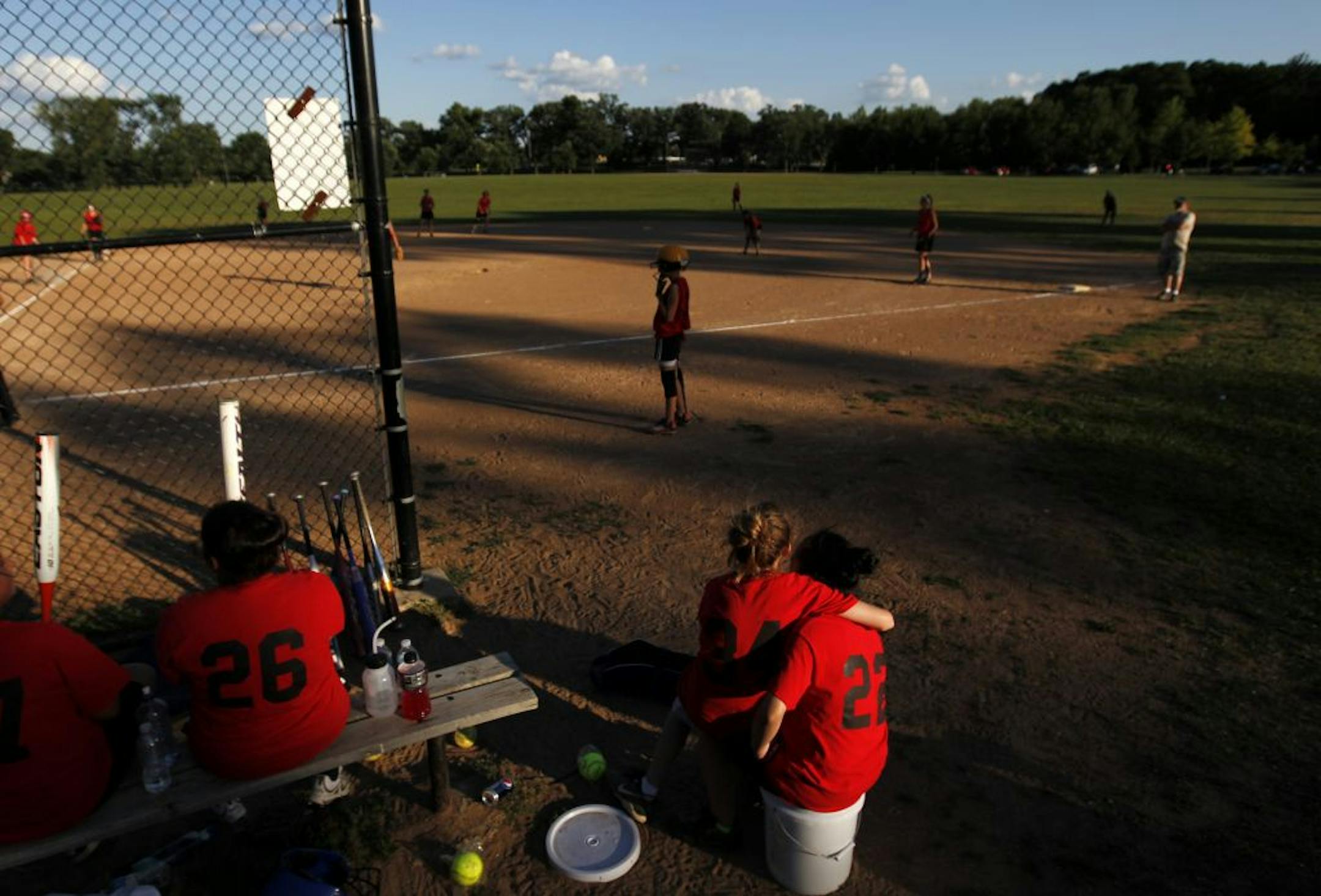 Miranda LaFavour, 13, sat on the lap of teammate Kelsey Xiong, 14, during a game between Phalen Girls Under 14 vs. Como Girls at Como Field in St. Paul.