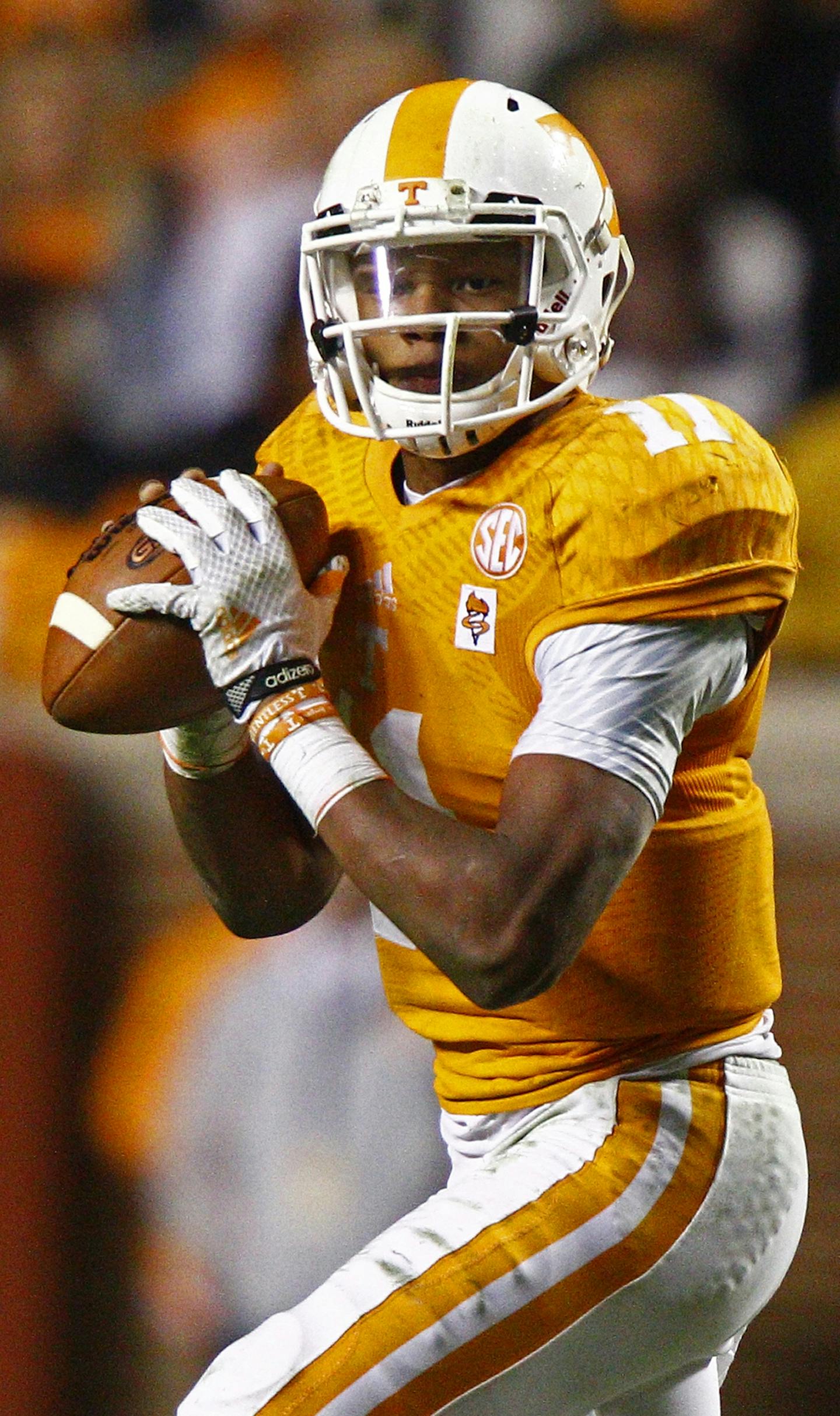 Tennessee quarterback Joshua Dobbs (11) looks for a receiver as he's pressured by Missouri defensive lineman Josh Augusta (97) in the second half of an NCAA college football game Saturday, Nov. 22, 2014 in Knoxville, Tenn. Missouri won 29-21. (AP Photo/Wade Payne) ORG XMIT: TNWP1