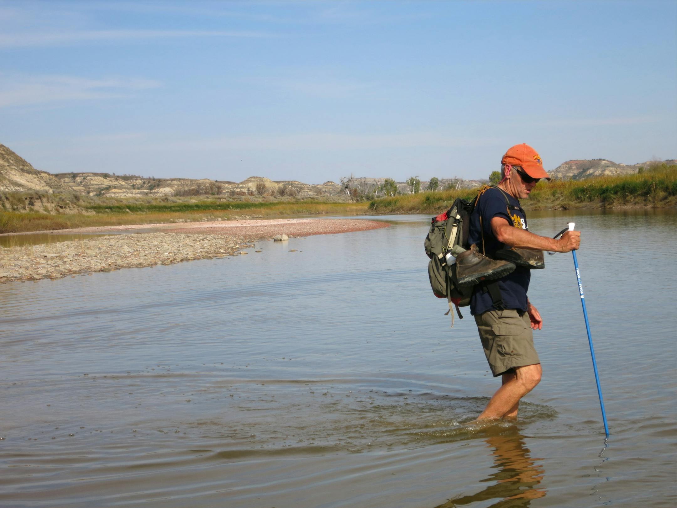 Photo by Nancy Conger. Author, Tom Anderson, fords the Little Missouri River while on an off-trail hike in the 41,000-plus acre south unit. Extra water, food, a compass and map are recommended when hiking off trails.