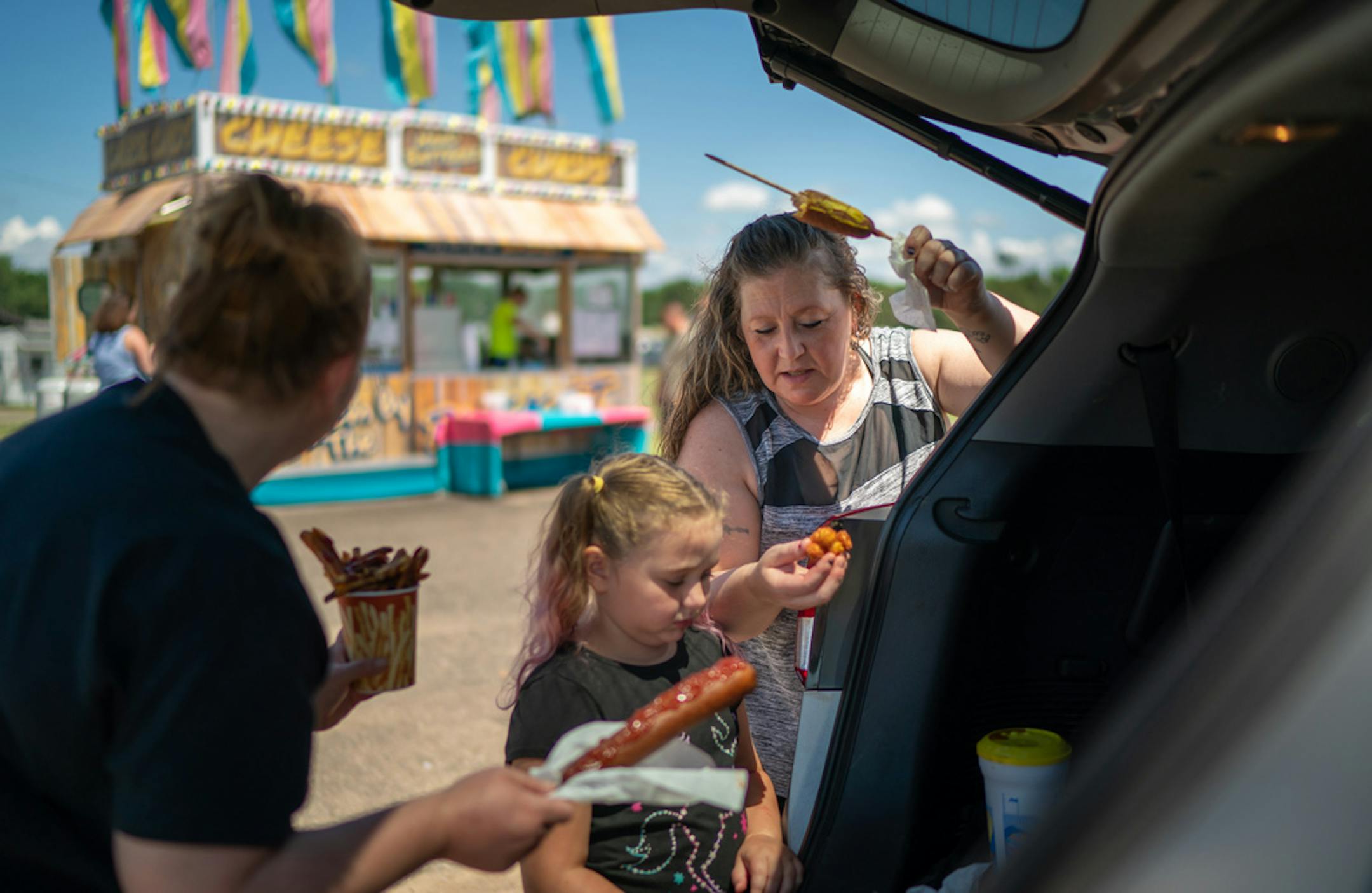 Darlynn Johnson, right, met her sister Deshia Anderson and her niece Ava, 7, for lunch in July at the lone stand selling corn dogs, fries and cheese curds at the Anoka County Fairground.