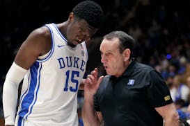 Duke center Mark Williams received direction from head coach Mike Krzyzewski during a game last season.