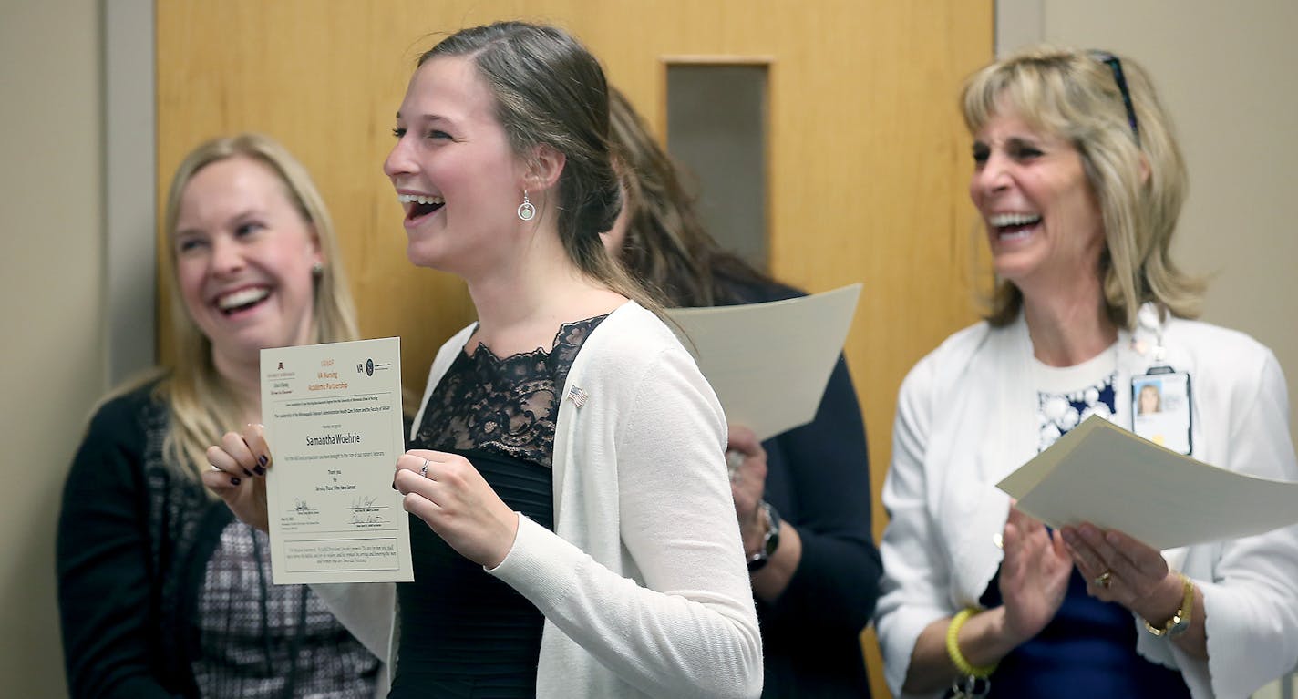 Nursing graduate Samantha Woehrle happily showed off her certificate as she turned to her family after receiving her nursing degree at the Minneapolis Veterans Administration Hospital, Friday, May 15, 2015 in Minneapolis, MN. Woehrle joined other graduates on Friday to receive a degree in nursing through a program known as The Veteran Affairs Nursing Academic Partnership Program (VANAP) and the University of Minnesota. They will work specifically with veterans. ] (ELIZABETH FLORES/STAR TRIBUNE)