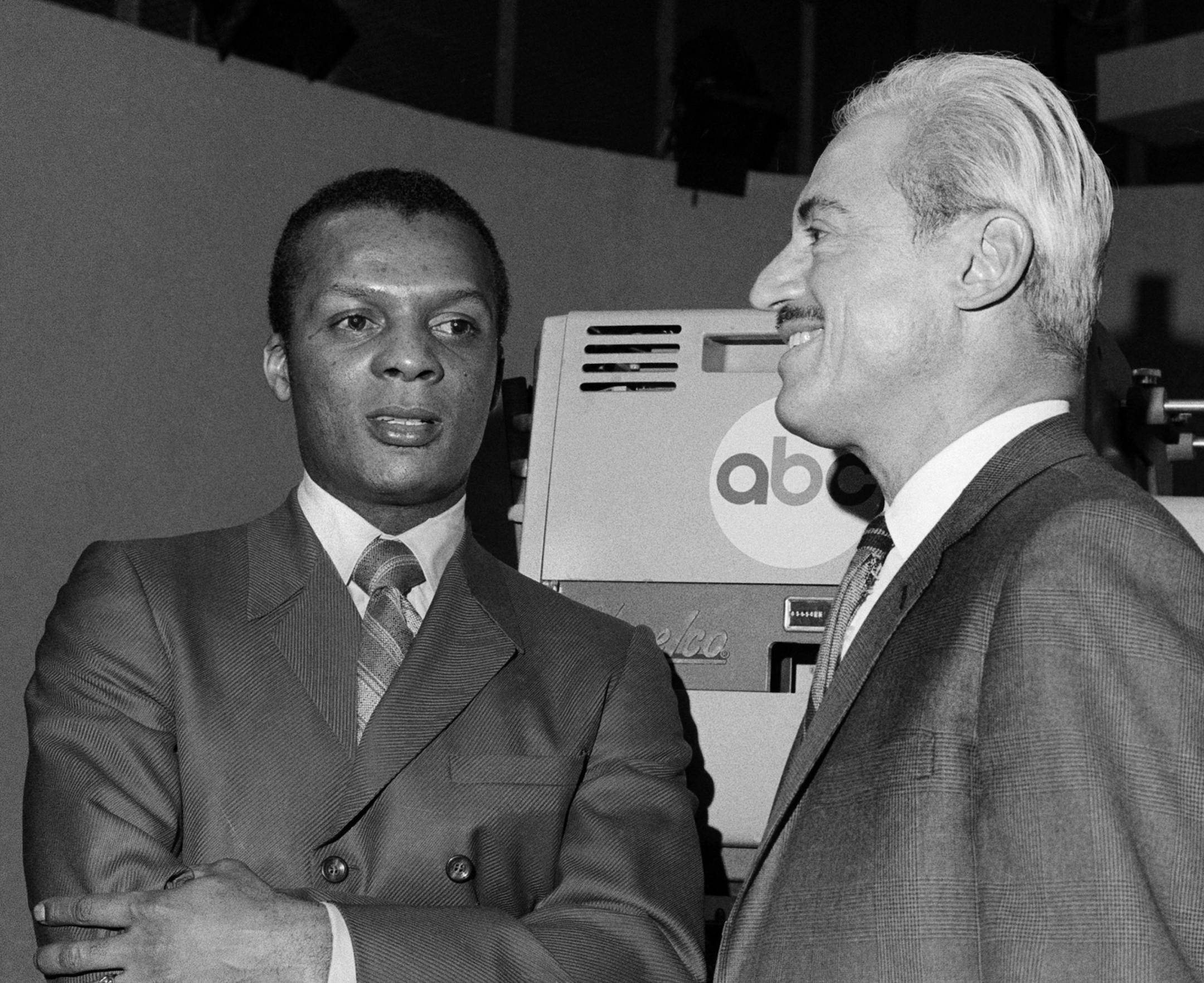 FILE - In this Jan. 3, 1970, file photo, baseball player Curt Flood, left, and Marvin Miller, Executive Director of the Baseball Players Association, wait inside ABC Television Studio before an appearance in New York. Flood set off the free-agent revolution 50 years ago Tuesday, Dec. 24, 2019, with a 128-word letter to baseball Commissioner Bowie Kuhn, two paragraphs that pretty much ended the career of a World Series champion regarded as among the sport's stars but united a union behind his cau