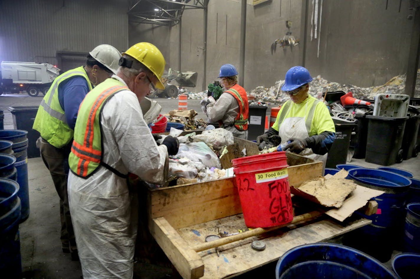 Waste sorters, who are contracted by Hennepin County, sift through trash to check the contents during a week-long study at the Hennepin Energy Recovery Center (HERC) in May 2016.