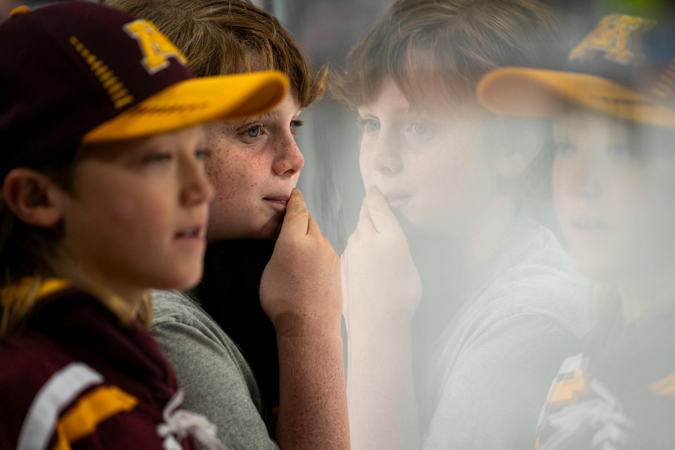 Nolan Appel (left) and Lucas Mills eagerly watch the University of Minnesota game against Bemidji State University.