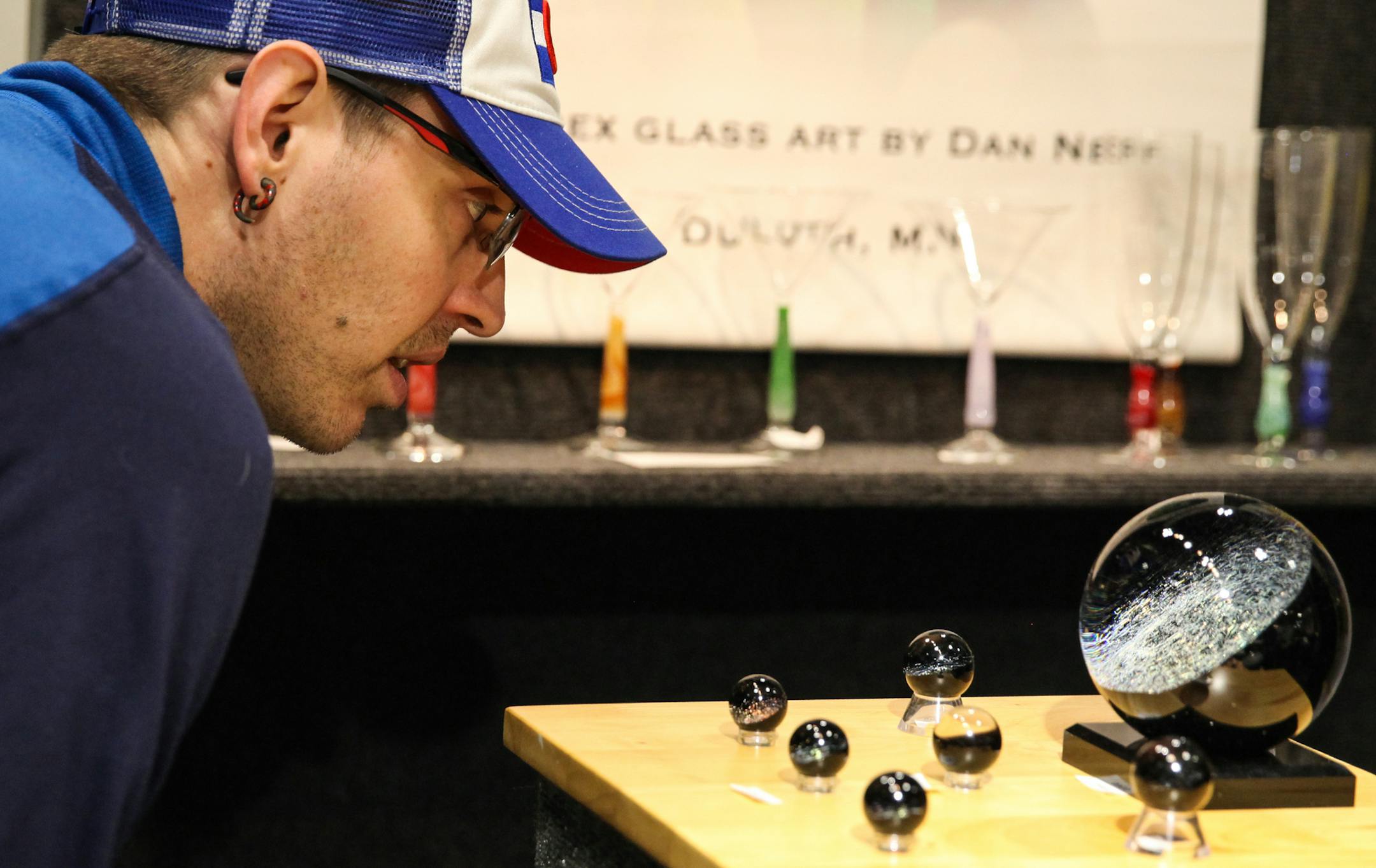 Andy LaBree, from Crystal, is looking at the art glass that made by Dan Neff from Duluth. ] XAVIER WANG • xavier.wang@startribune.com The American Craft Show returns to St. Paul on April 7th to 9th, 2017 at the RiverCenter in St. Paul, and more than 225 artists from the entire country attend the show.