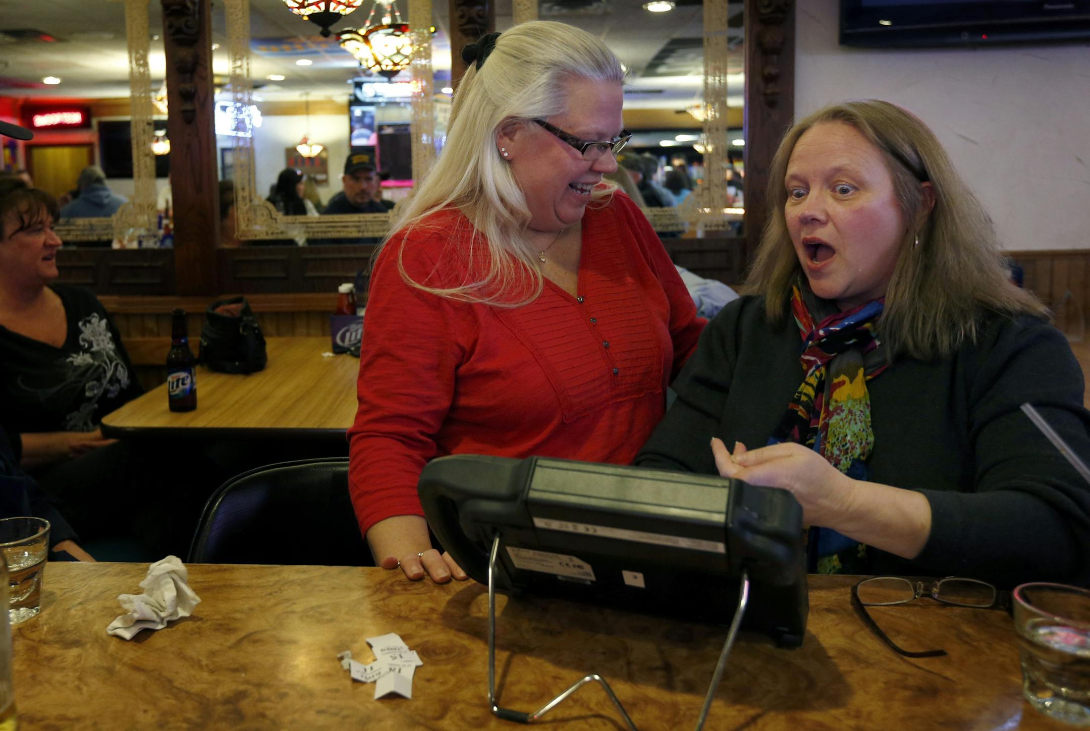 Rona Nesser helped Wendy Hedges play on an electronic bingo tablet at the Blainebrook Entertainment Center in Blaine on Thursday. Nesser had learned to use the device earlier and was assisting her friend. ] CARLOS GONZALEZ cgonzalez@startribune.com March 27, 2013, Blaine, Minn., The Blainebrook Entertainment Center is one of the two or three test sites for the new electronic linked bingo games. Electronic linked bingo, the second leg of Minnesota's plan to fund the Minnesota Vikings stadium, is