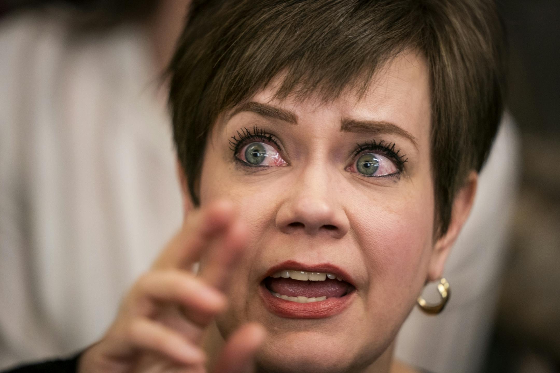 Jen Moeller, a former clinical instructor in the dental hygiene program at Argosy University, gets emotional while talking to legislators after the hearing.