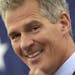 FILE - In this March 14, 2014 file photo, former Massachusetts Senator Scott Brown acknowledges his wife Gail in Nashua, N.H., as he announces plans t