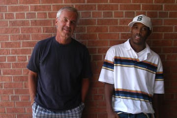 L to R The two winners of $25,000 screenwriting prize from McKnight, radio personality Bob Yates, and a young Minneapolis man named Michael Starrbury 