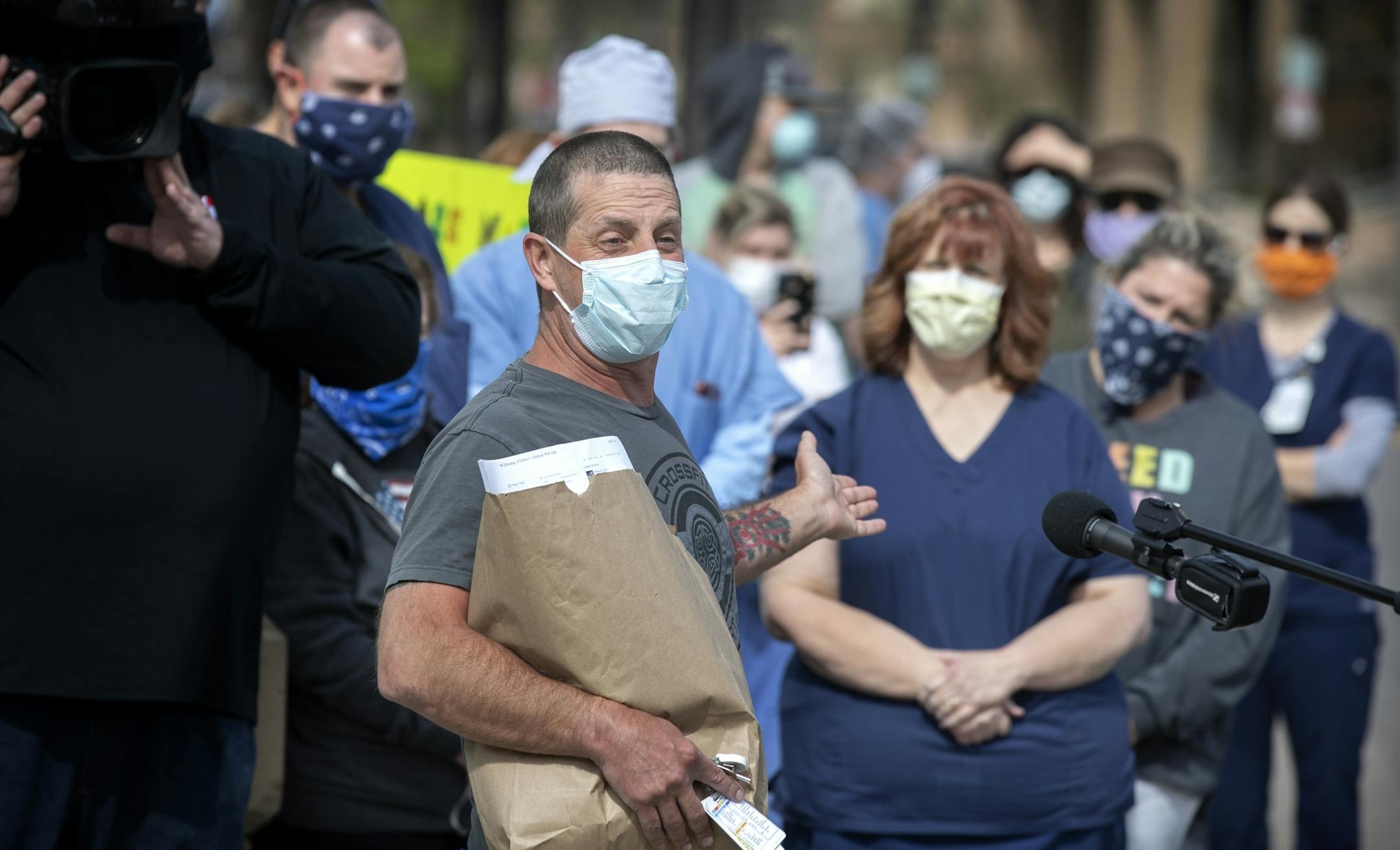 Cliff Willmeng (cq) a frontline emergency room nurse at United Hospital and other nurse protested on the sidewalk outside of the hospital .