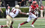Louisville quarterback Lamar Jackson (8) avoids the tackle form Florida State defensive end DeMarcus Walker (44) during the third quarter of an NCAA c