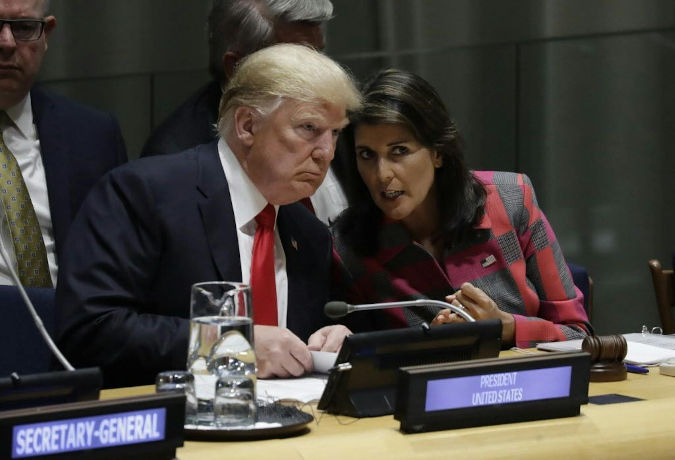 President Donald Trump talks to Nikki Haley, the U.S. ambassador to the United Nations, at the United Nations General Assembly, Monday, Sept. 24, 2018, in New York.