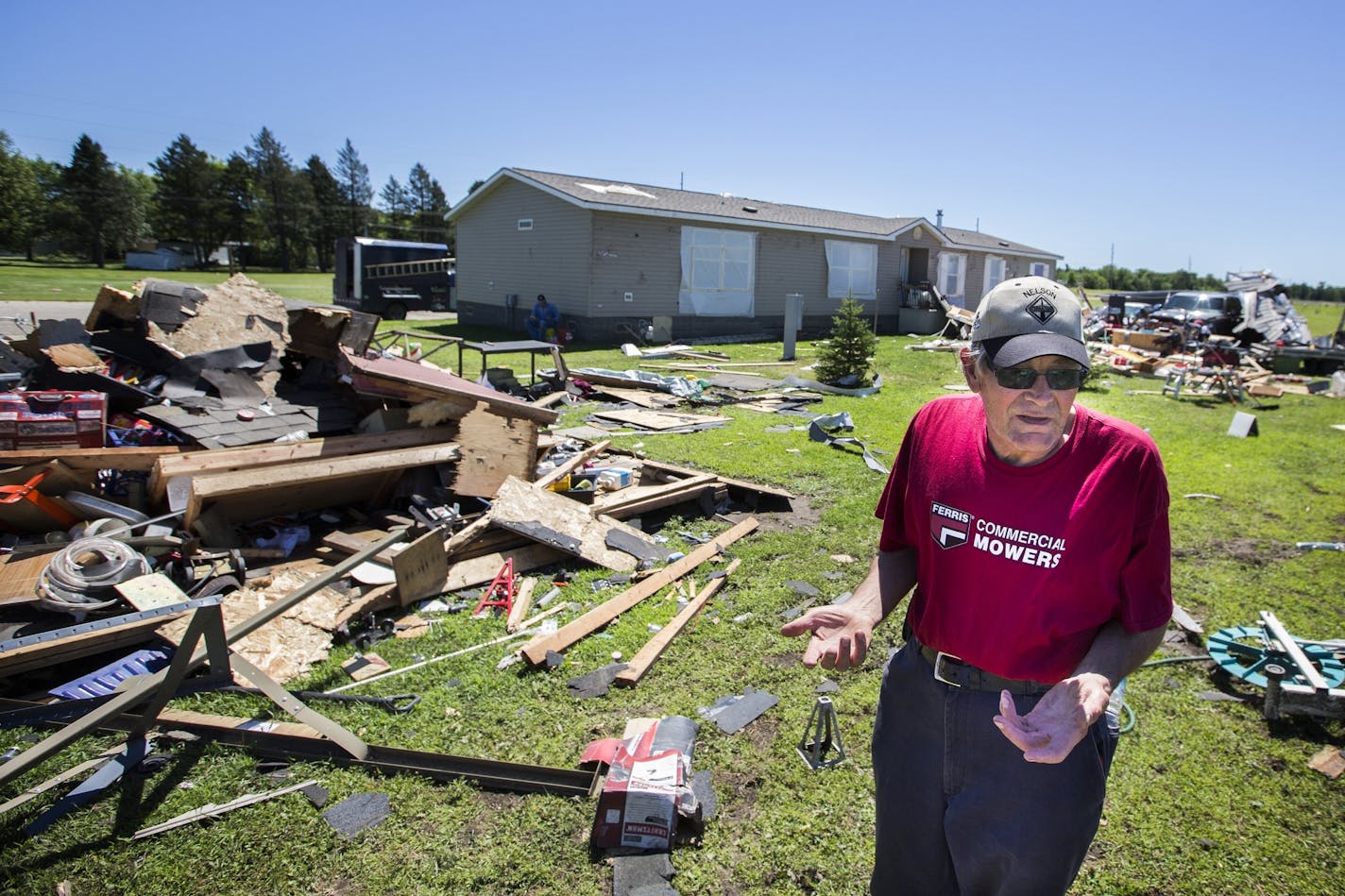 Brian Kelbing, who is the resident manager of the Park Village Mobile Home Park with his wife, assesses damage to their garage, totally destroyed by a tornado in Litchfield around 5 p.m. Monday.