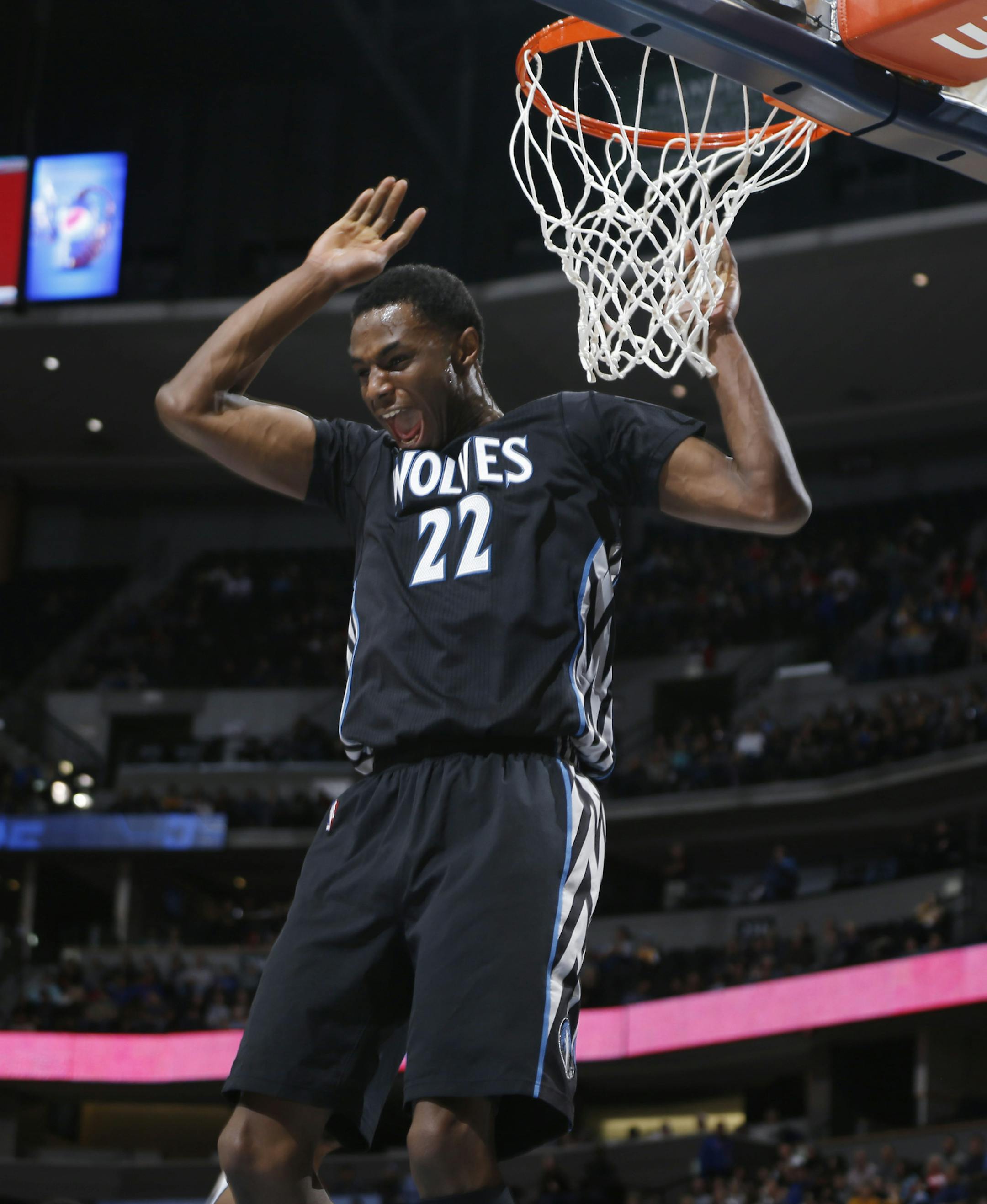 Minnesota Timberwolves forward Andrew Wiggins reacts after missing a pass for potential dunk against the Denver Nuggets in the first quarter of an NBA basketball game Saturday, Jan. 17, 2015, in Denver. (AP Photo/David Zalubowski)