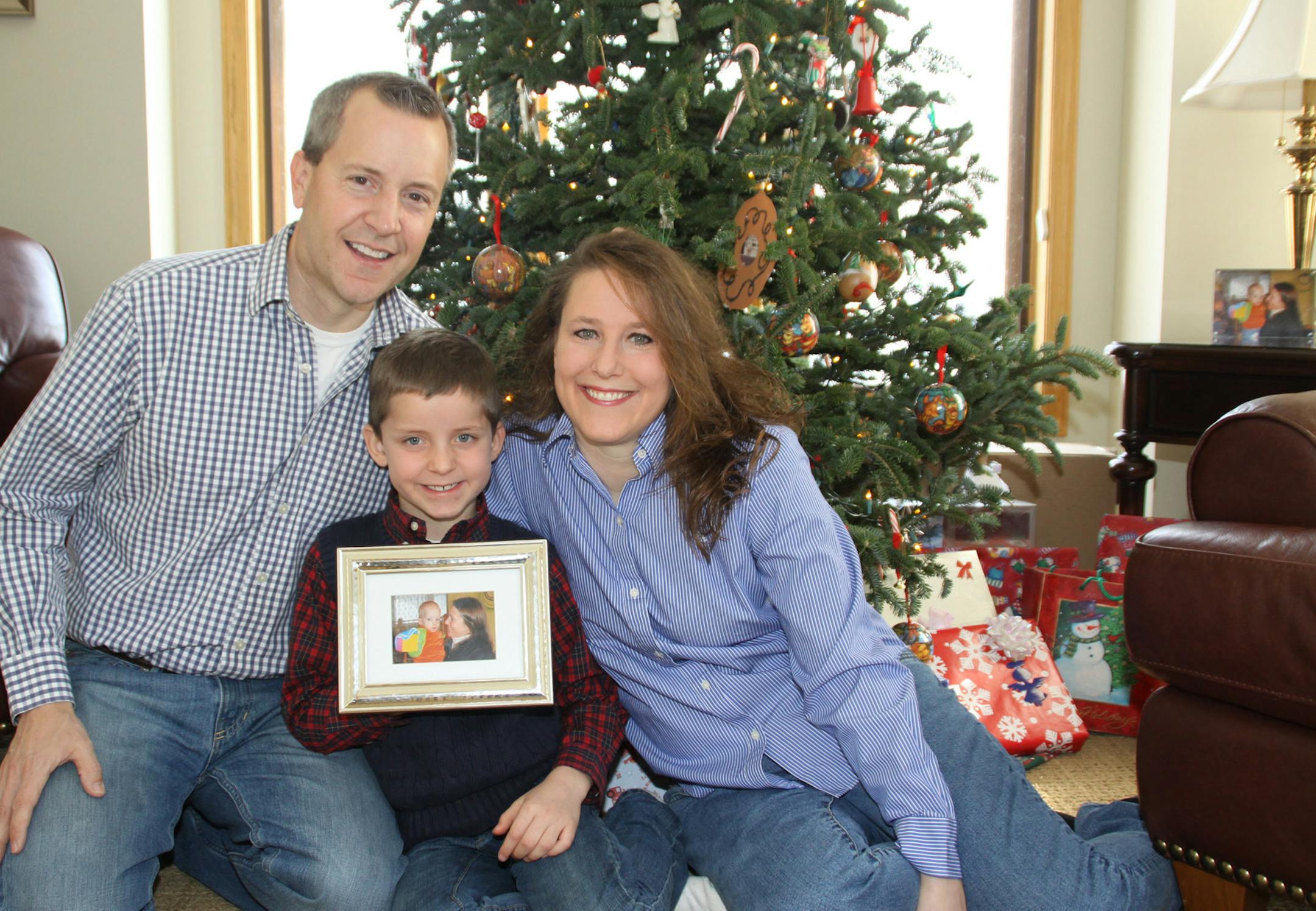 FILE - This December 2012 photo provided by the family shows, from left, John, Jack and Renee Thomas at their home in Minnetrista, Minn. Jack was adopted from Russia in 2008. On Thursday, Feb. 6, 2014, Renee went on television in Russia with an emotional appeal for an exception to be made to Russia's year-old ban on adoptions by Americans. She and her husband adopted a boy from Russia in 2008 and refuse to give up long-standing efforts to also adopt Nikolai, their son's biological brother. (AP P