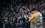 Karl-Anthony Towns, right, and Jeff Teague celebrate after the team's win over Denver