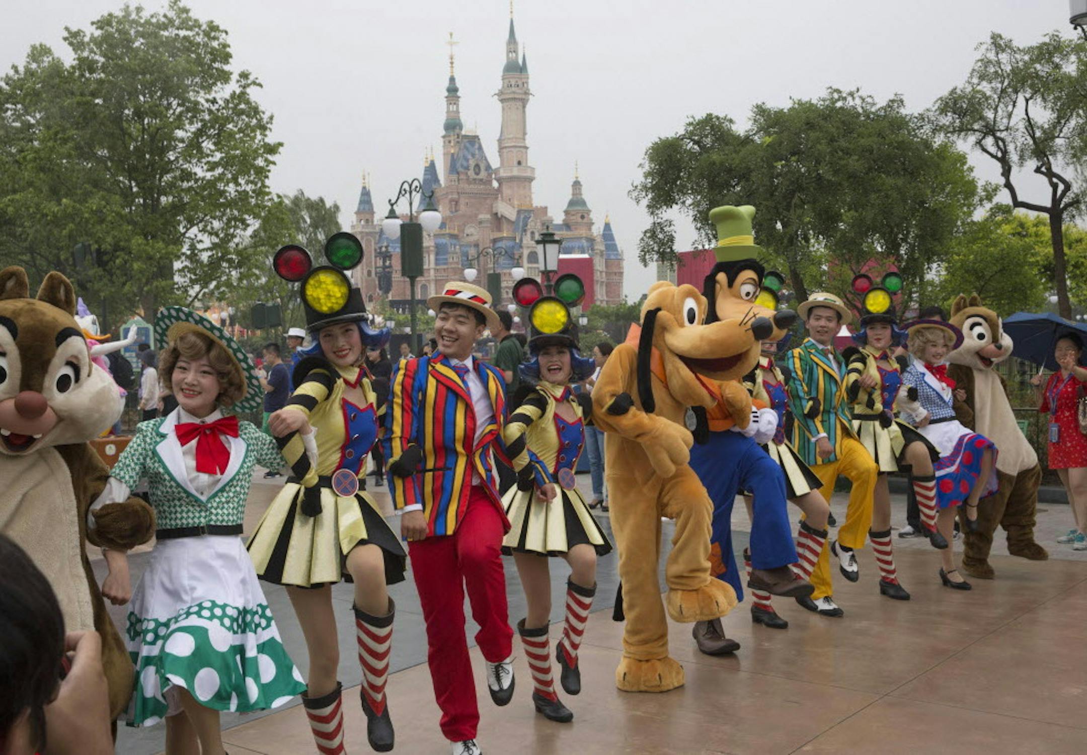 Performers take part in a parade at the Disney Resort in Shanghai, China, Wednesday, June 15, 2016 on the eve of its grand opening. The debut of Shanghai Disneyland offers Walt Disney Co. "incredible potential" for boosting its brand in the world's most populous market, Disney's chief executive said Wednesday ahead of Thursday's grand opening for the $5.5 billion park. (AP Photo/Ng Han Guan)