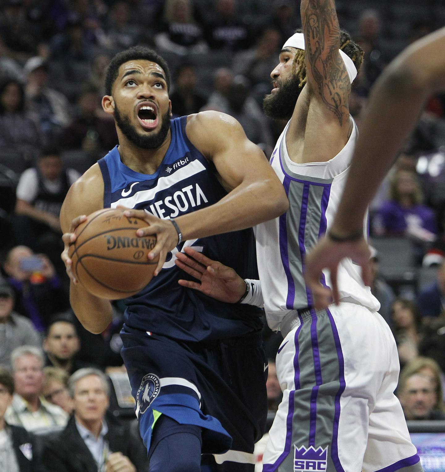 Minnesota Timberwolves center Karl-Anthony Towns (32) drives to the basket against Sacramento Kings center Willie Cauley-Stein (00) during the first half of an NBA basketball game in Sacramento, Calif., Friday, Nov. 9, 2018. (AP Photo/Steve Yeater)