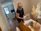 Shelly Billiet of Edina Realty prepares for an open house at a three-bedroom house she has listed in St. Louis Park for $389,900.