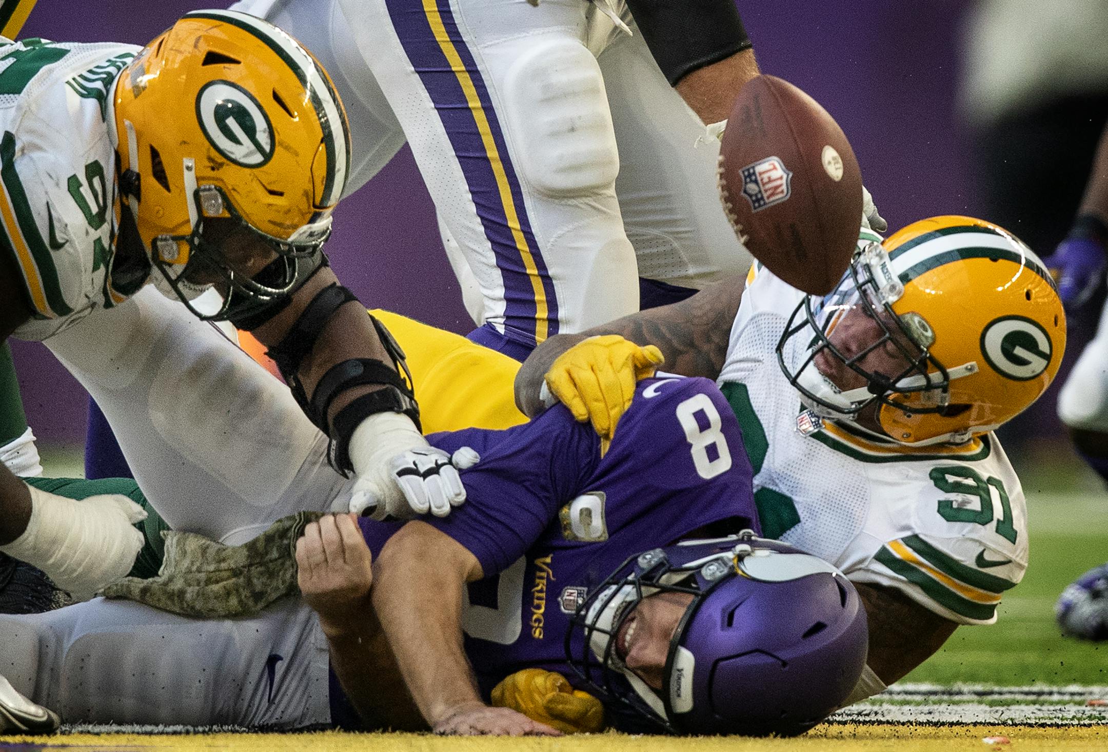 Minnesota Vikings quarterback Kirk Cousins (8). was sacked by Green Bay Packers outside linebacker Preston Smith (91), forcing a fumble that was recovered by Minnesota in the third quarter.
