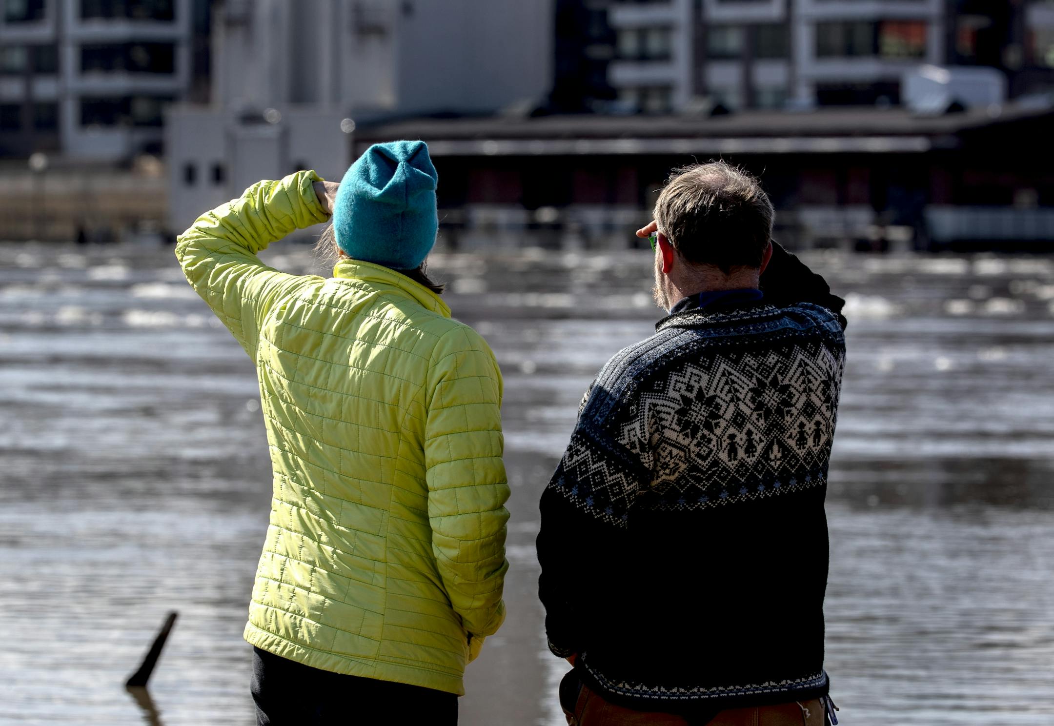 Pedestrians came out to view the flooding at Harriet Island Regional Park and the flowing Mississippi river on Monday afternoon.