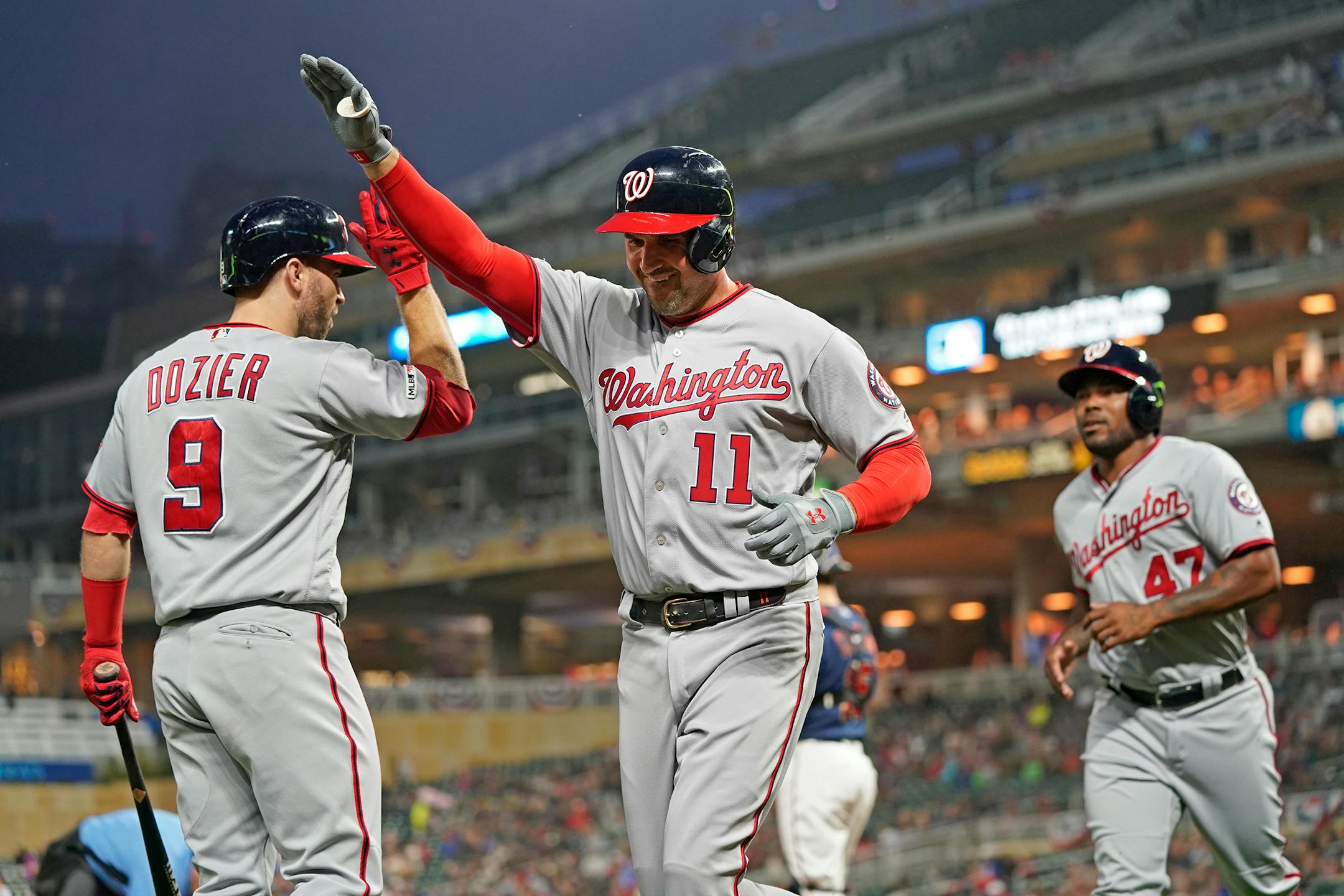 The Nationals' Ryan Zimmerman (11) got a high-five from teammate and former Twin Brian Dozier after Zimmerman's two-run homer in the third inning.