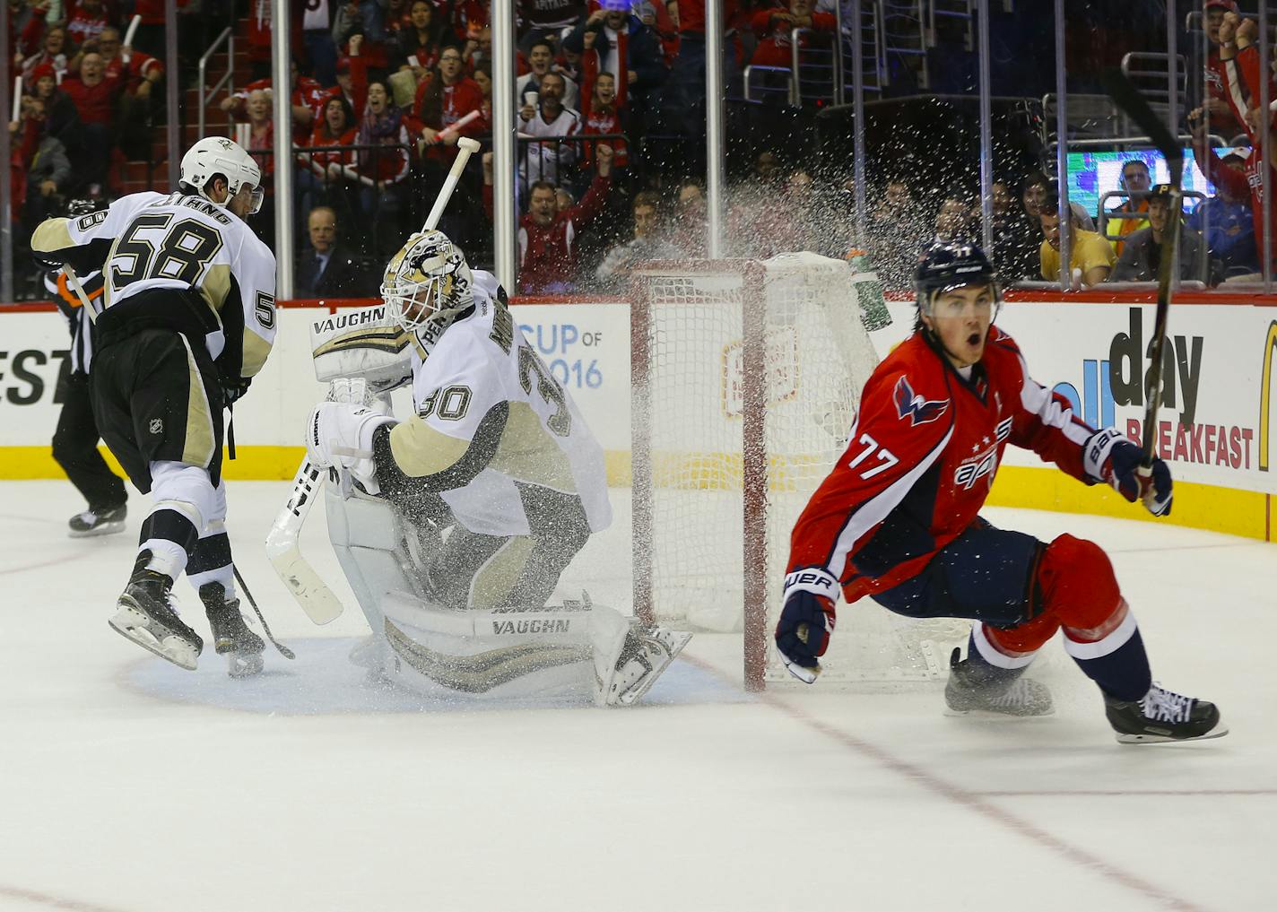 Washington Capitals right wing T.J. Oshie (77) starts to celebrate his goal against Pittsburgh Penguins goalie Matt Murray (30) and Kris Letang (58) during the second period of Game 1 in an NHL hockey Stanley Cup Eastern Conference semifinals Thursday, April 28, 2016 in Washington. (AP Photo/Pablo Martinez Monsivais)