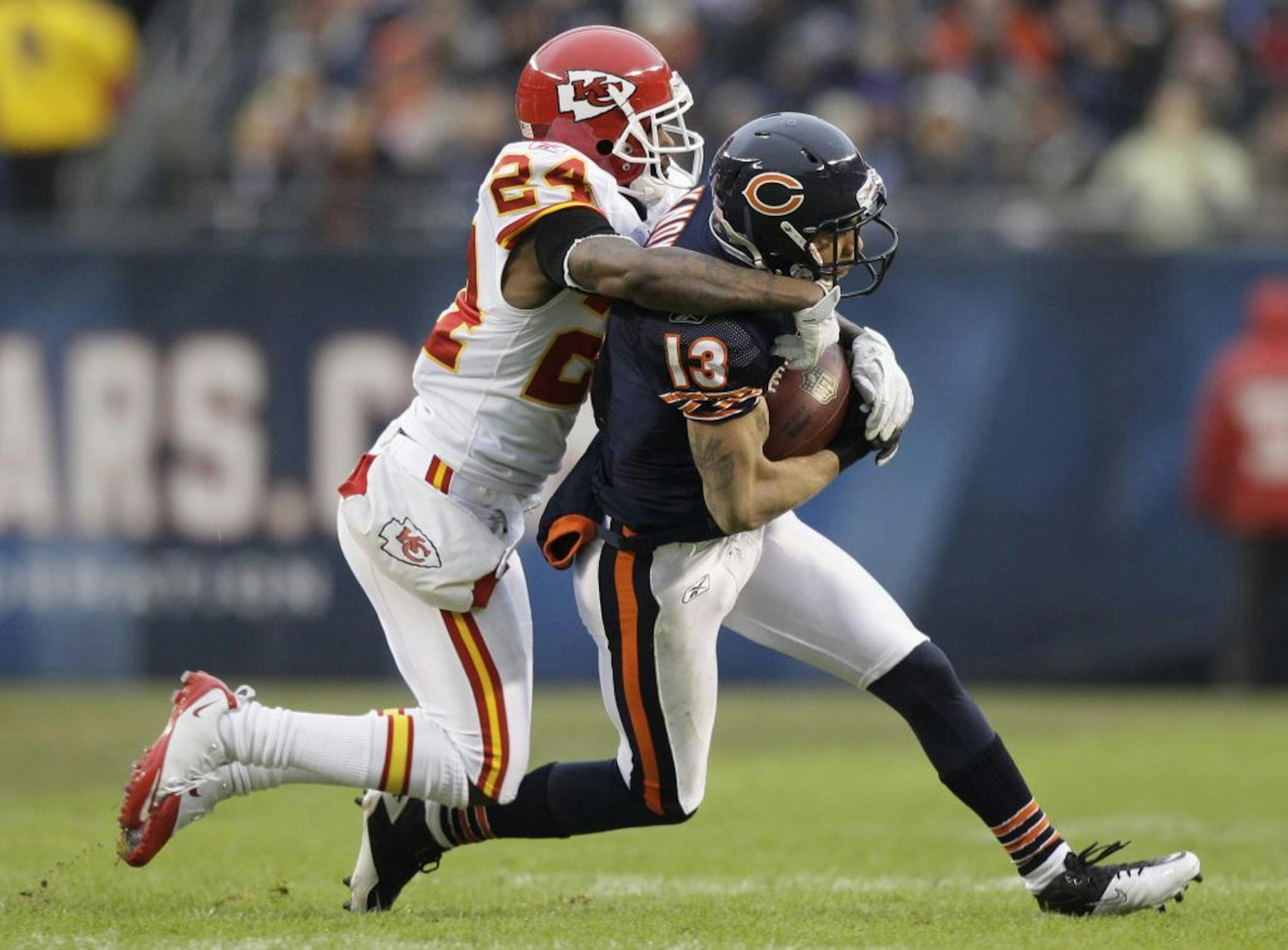 Chicago Bears wide receiver Johnny Knox (13) is tackled by Kansas City Chiefs cornerback Brandon Flowers (24) in the first half of an NFL football game in Chicago, Sunday, Dec. 4, 2011.