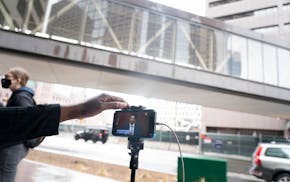 A woman played the livestream of the Derek Chauvin trial on her phone hooked up to a speaker outside of the Hennepin County Government Center where th