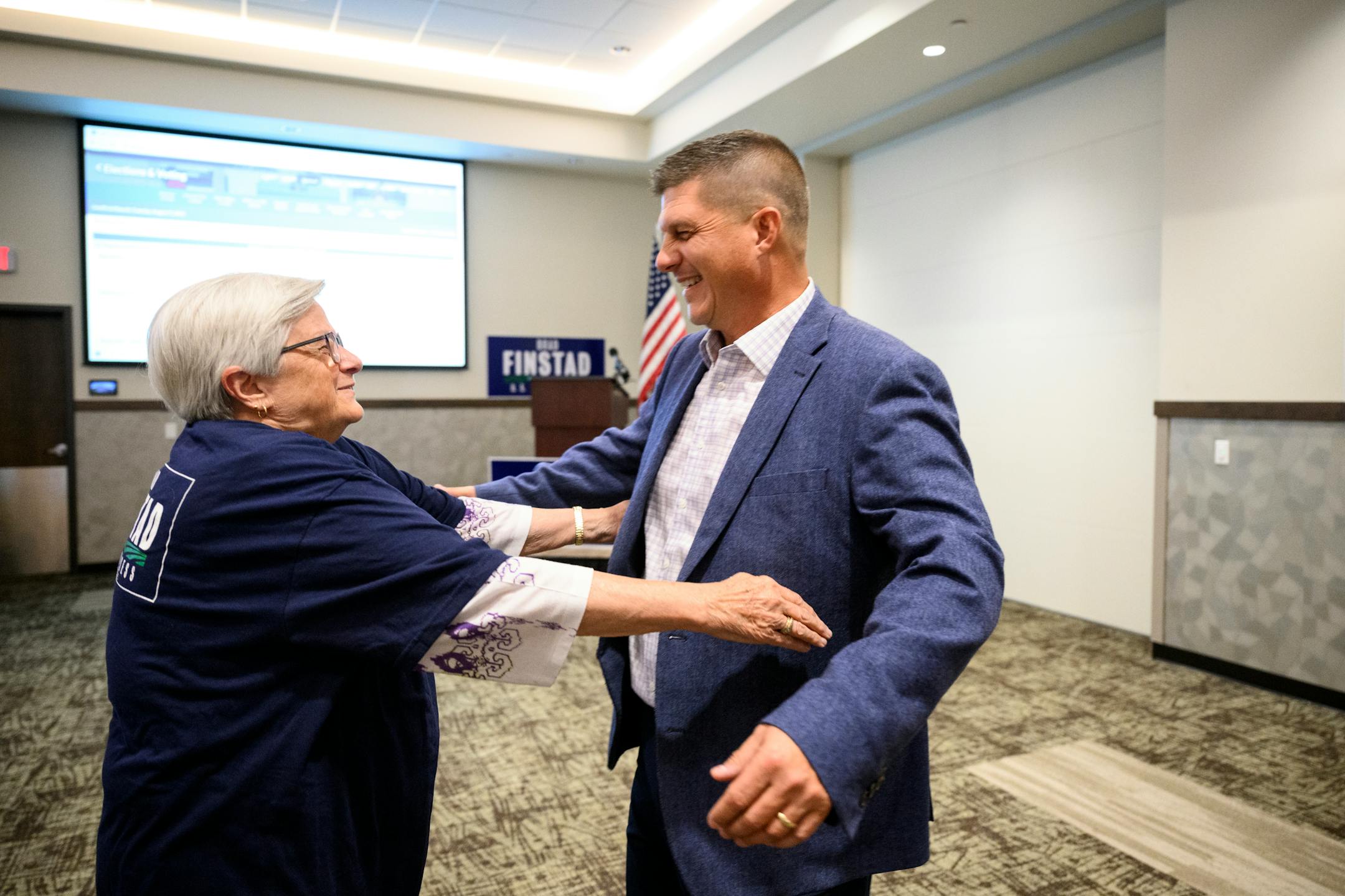 GOP congressional candidate Brad Finstad hugs his mother, Sharon Finstad, after Finstad gave a speech after his campaign announced his victory in the primaries during an election night party.