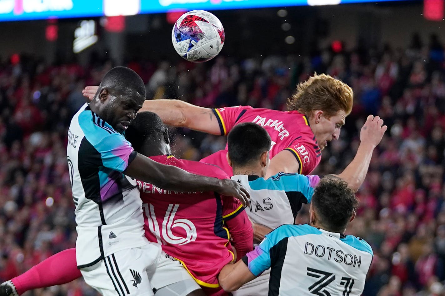 Minnesota United's Kemar Lawrence, left, and St. Louis City's Tim Parker, top right, battle for the ball during the second half of an MLS soccer match Saturday, April 1, 2023, in St. Louis. (AP Photo/Jeff Roberson)