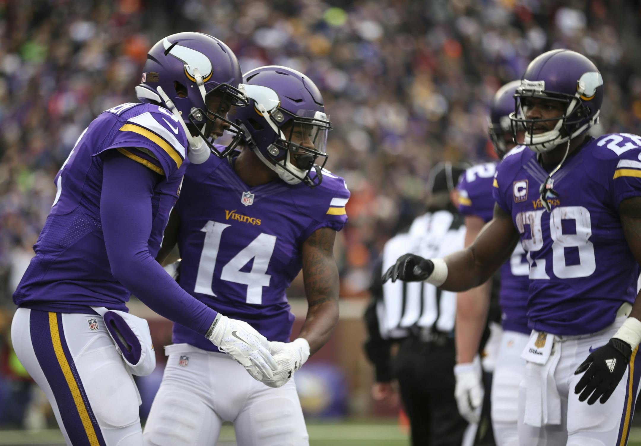 Vikings quarterback Teddy Bridgewater (5) and Vikings wide receiver Stefon Diggs (14) celebrated their 15 yard touchdown in the first quarter Sunday. Vikings running back Adrian Peterson awaited his turn at right.
